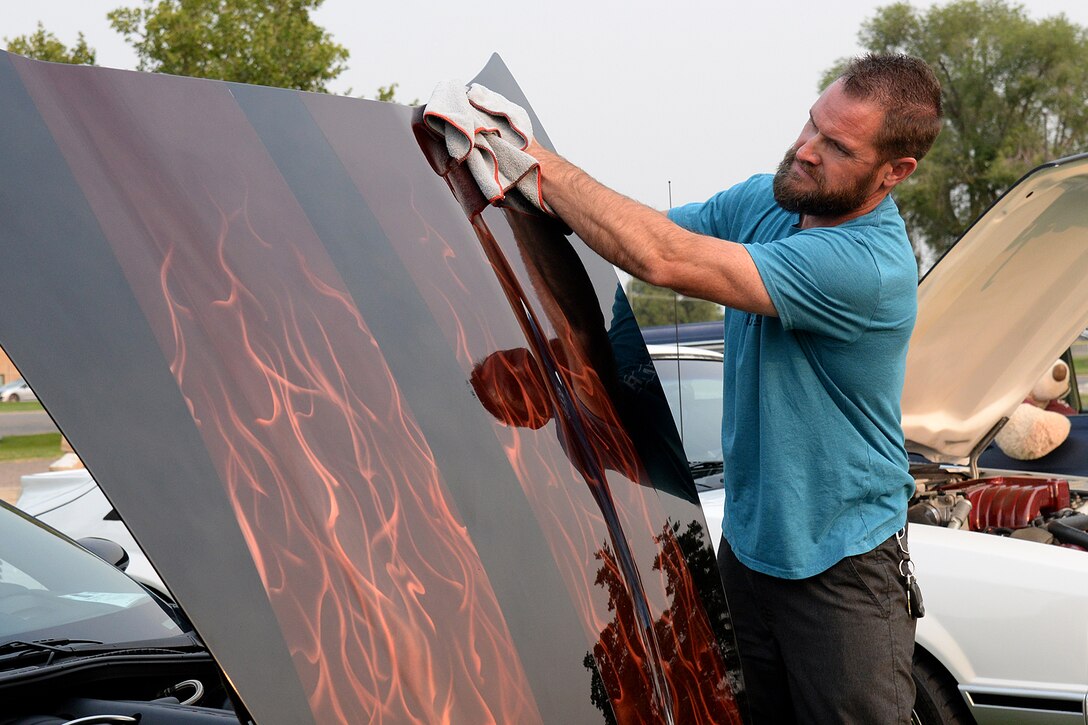 Kyle Kendall shines the flames painted on the hood of his 2006 Chevrolet Corvette.