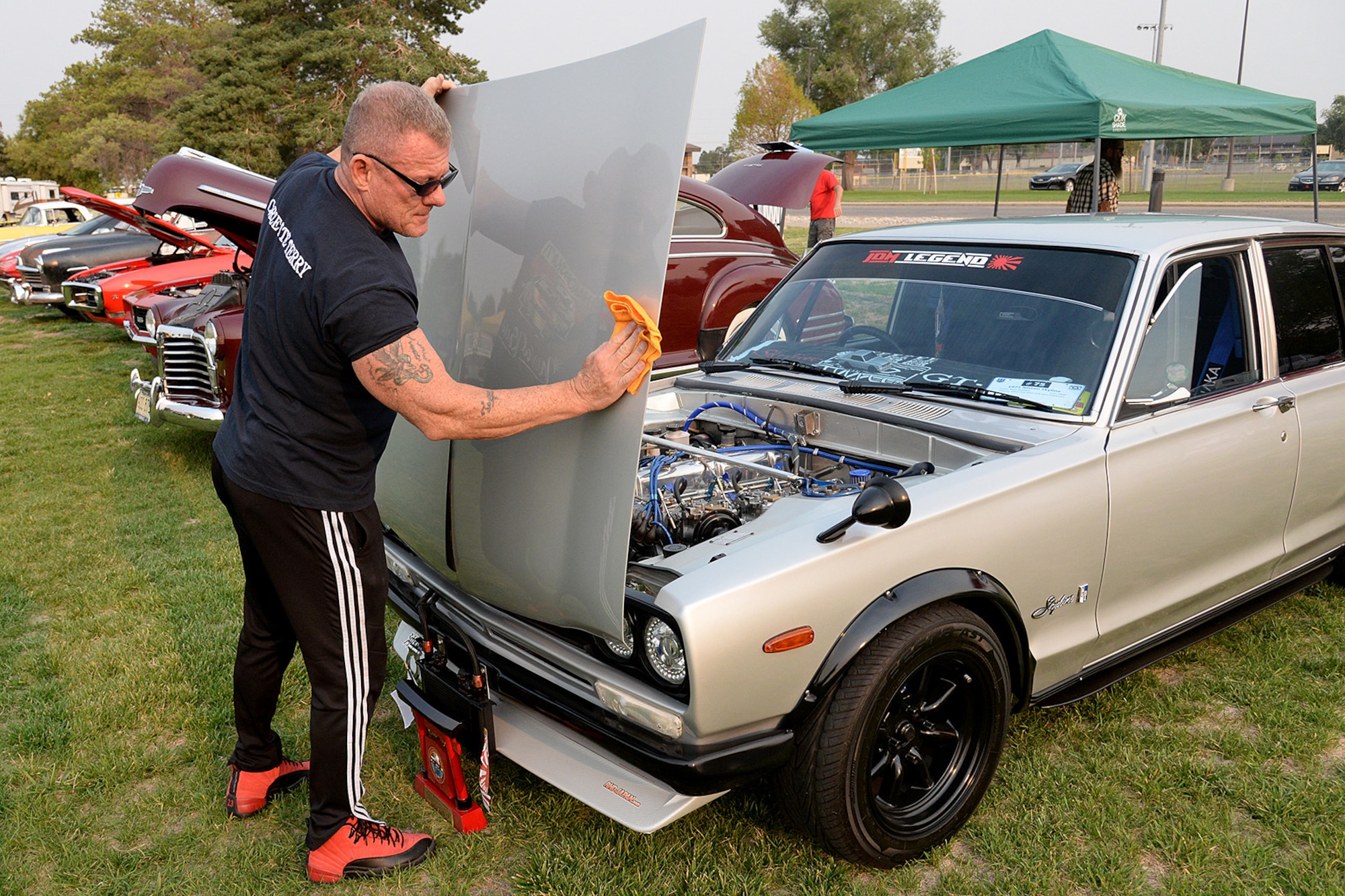 Terry Baldwin shines the reverse hood of his 1971 GTR Spec Hakosuka.