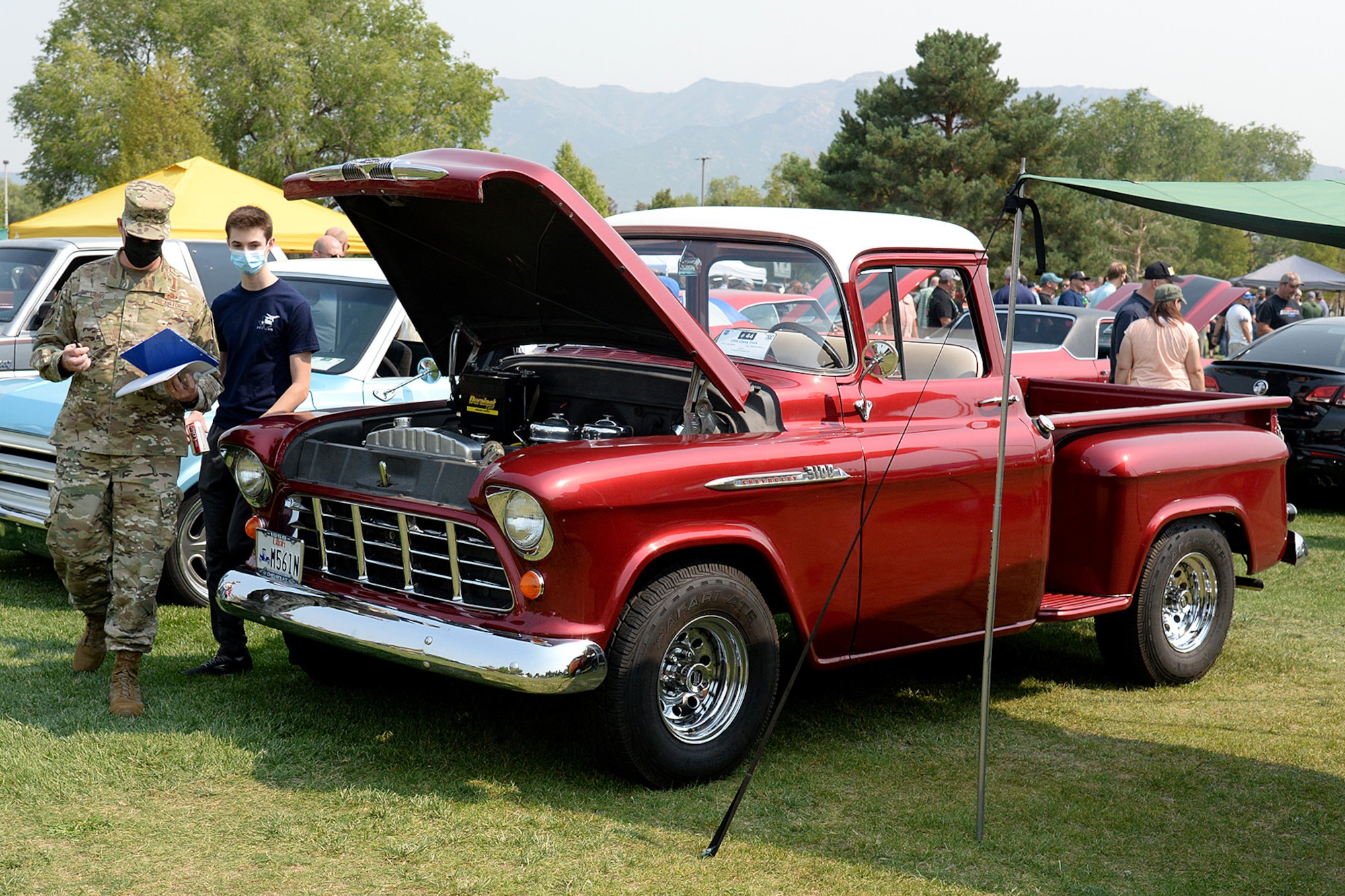 Brig. Gen. Richard Gibbs, Ogden Air Logistics Complex commander, and his son Collin walk in front of a 1956 Chevy 3100 pickup.