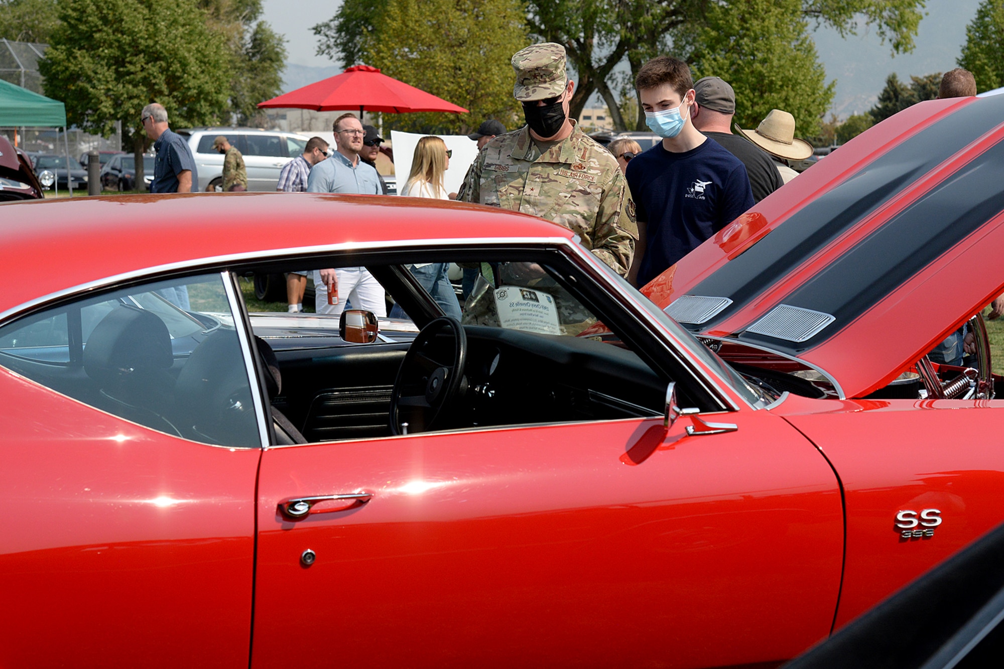 Brig. Gen. Richard Gibbs, Ogden Air Logistics Complex commander, and his son Collin looking at a vehicle.