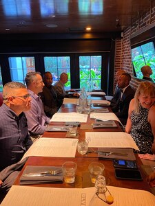 Adults sharing a meal around a table.