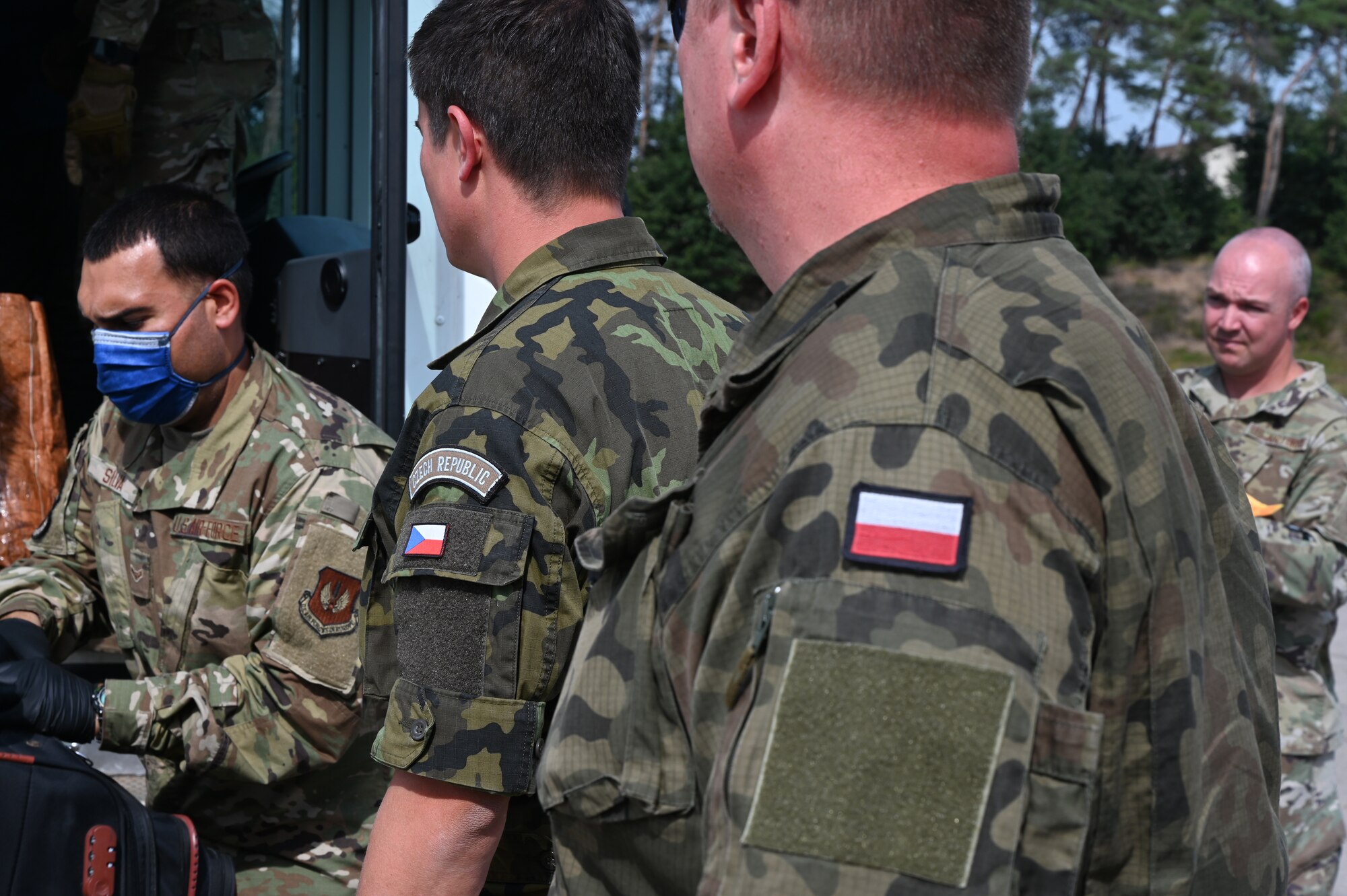 NATO members stand by to help move luggage at Ramstein Air Base, Germany, Sept. 7, 2021. NATO allies have been essential in assisting in Operation Allies Refuge and have helped support evacuees and partners alike. (U.S. Air Force photo by Senior Airman Thomas Karol)