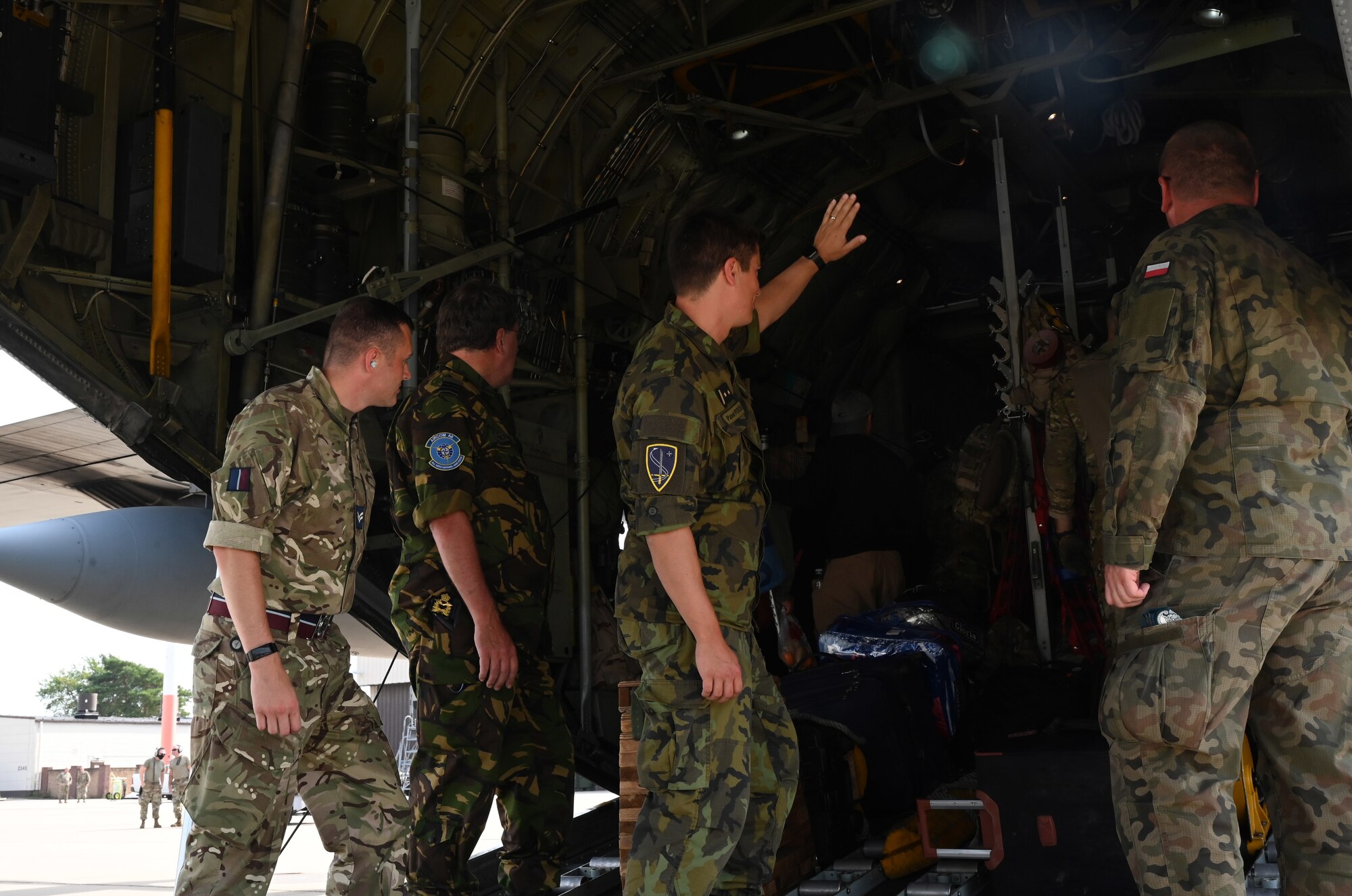 Czech Air Force Lt. Col. Pavel Petrzela, waves goodbye to evacuees at Ramstein Air Base, Germany, Sept. 7, 2021. NATO members are taking an active role in helping evacuees transition in to their new lives as they move to an onward location. (U.S. Air Force photo by Senior Airman Thomas Karol)