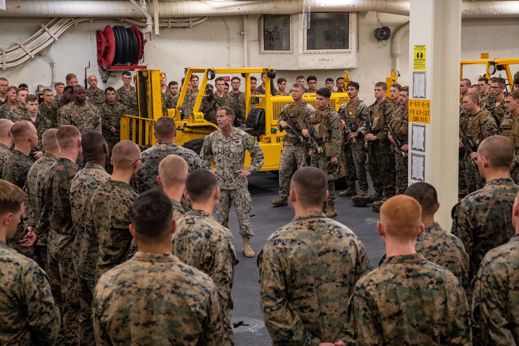 U.S. Navy Rear Admiral Keith Davids, commanding officer of Joint Task Force-Haiti (JTF-Haiti), speaks with U.S. Marines with JTF-Haiti while aboard the USS Arlington (LPD 24), Sept. 1, 2021. Leaders with JTF-Haiti and U.S. Agency for International Development visited the U.S. Marines and sailors aboard the ship to thank them for their efforts in support of the humanitarian assistance and disaster relief mission. (U.S. Marine Corps photo by Cpl. Alize Sotelo)
