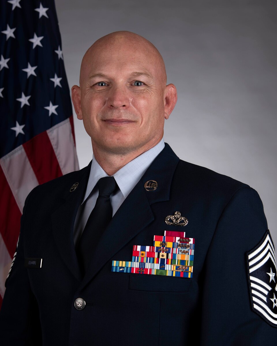Man in Air Force uniform sits for official bio photo