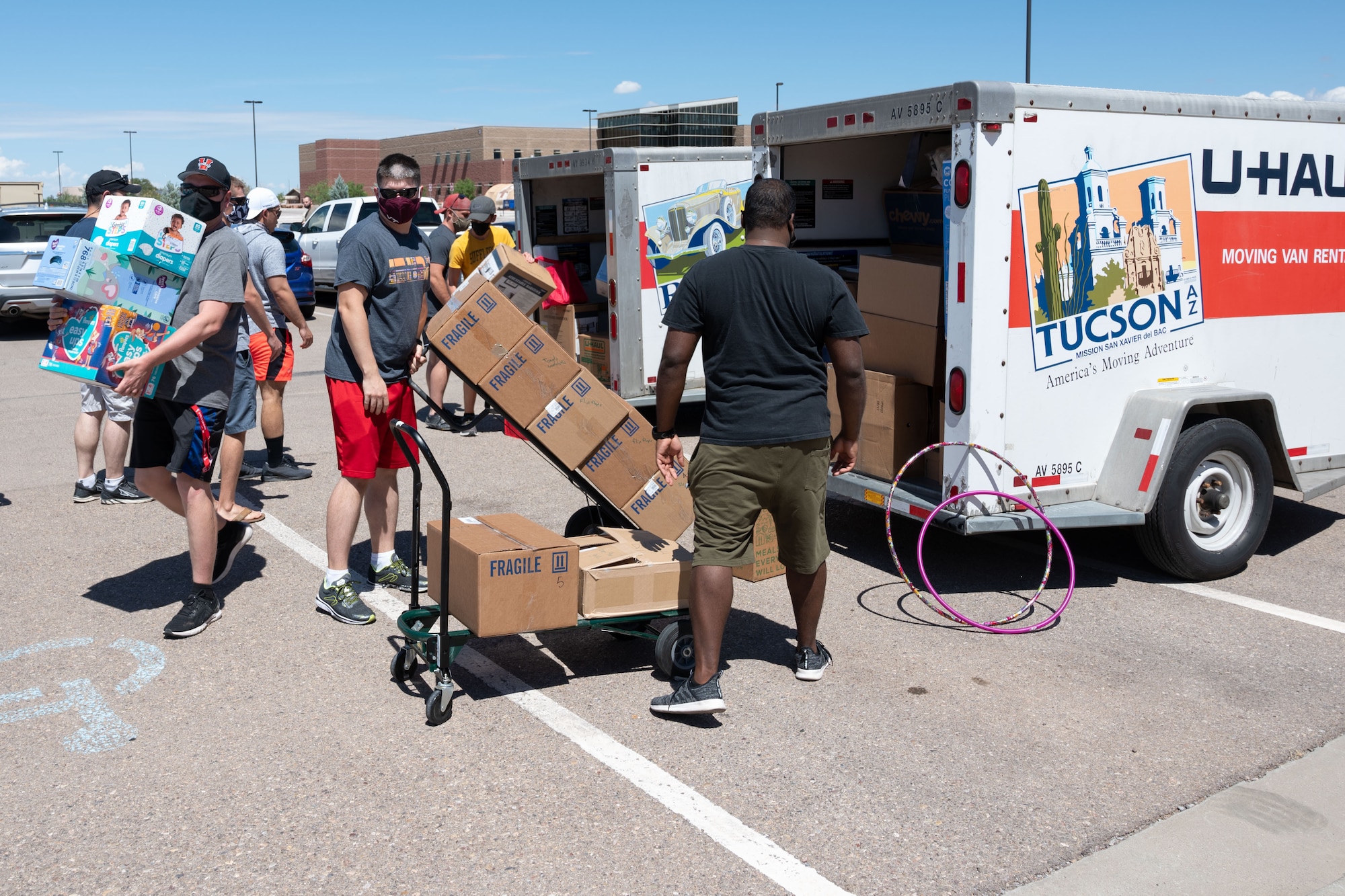 Volunteers unload boxes of donations from moving trailers Sept. 3, 2021 on Holloman Air Force Base, New Mexico. Volunteers from the Cannon AFB, N.M., community collected and delivered a donation valued at $80,000 in support of Operation Allies Welcome. The Department of Defense, through U.S. Northern Command, and in support of the Department of Homeland Security, is providing transportation, temporary housing, medical screening, and general support for up to 50,000 Afghan evacuees at suitable facilities, in permanent or temporary structures, as quickly as possible. This initiative provides Afghan personnel essential support at secure locations outside Afghanistan. (U.S. Air Force photo by Tech. Sgt. BreeAnn Sachs)