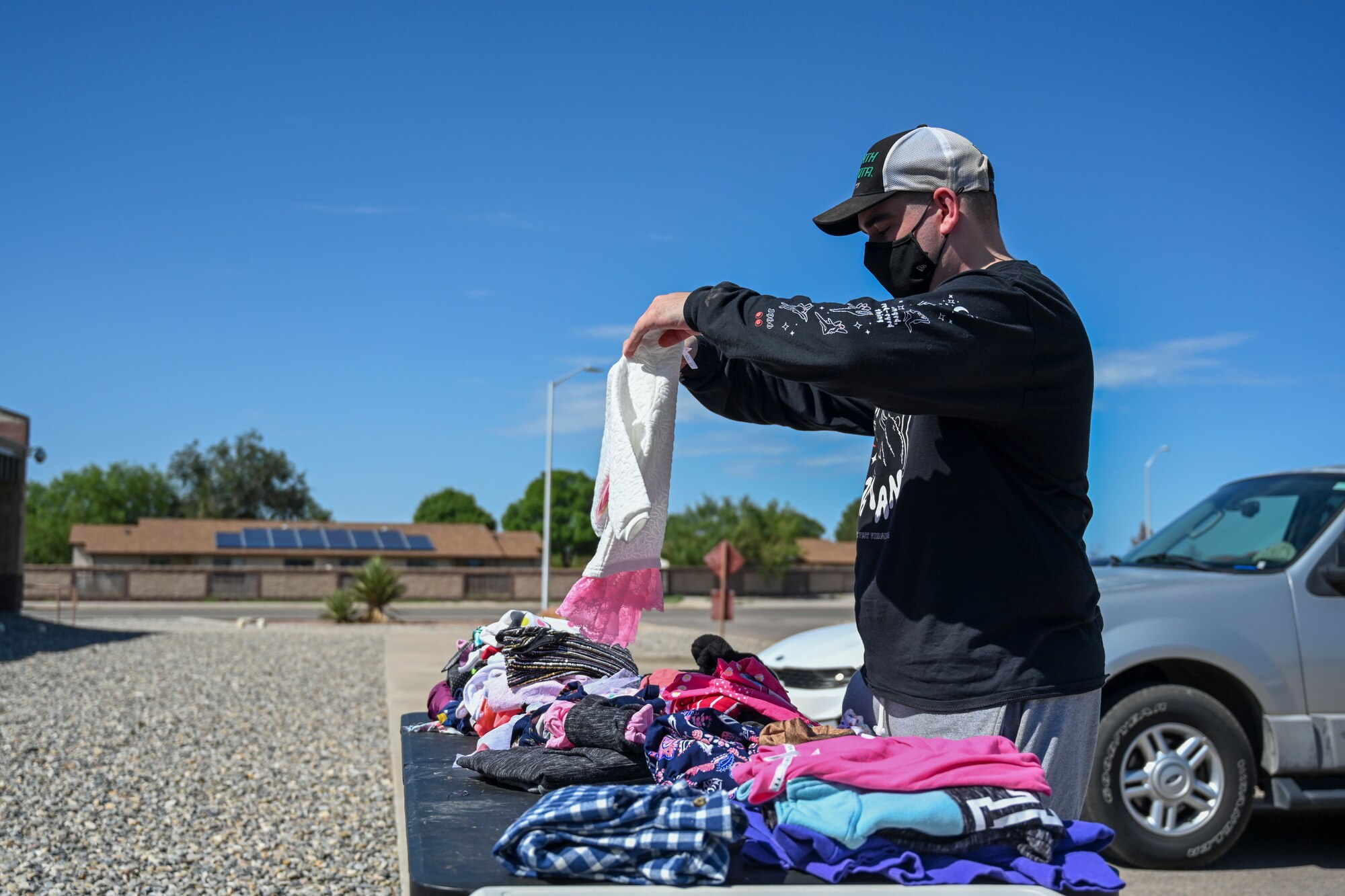 A volunteer folds and sorts children’s clothes at the Holloman donation center Aug. 30, 2021 on Holloman Air Force Base, New Mexico. Holloman community partners coordinated and collected donations in support of Operation Allies Welcome. The Department of Defense, through U.S. Northern Command, and in support of the Department of Homeland Security, is providing transportation, temporary housing, medical screening, and general support for up to 50,000 Afghan evacuees at suitable facilities, in permanent or temporary structures, as quickly as possible. This initiative provides Afghan personnel essential support at secure locations outside Afghanistan. (U.S. Air Force photo by Airman 1st Class Adrian Salazar)