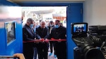 The recently retired Director of Al Muthanna Veterinary Hospital, Dr. Abdul Kareem Abdul Zahra (center), cuts the ribbon at the opening ceremony of Muthanna Veterinary Laboratory,