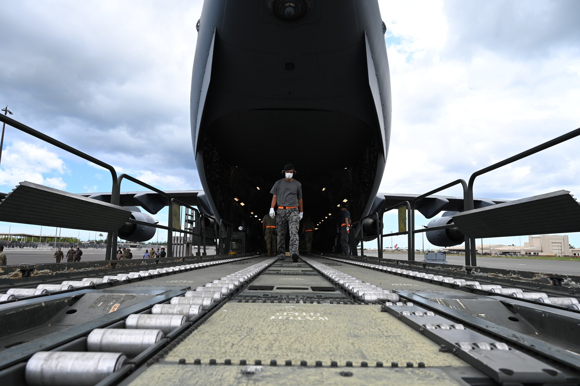 Photo of a Japanese Airman inspecting a C-17 Globemaster III ramp.