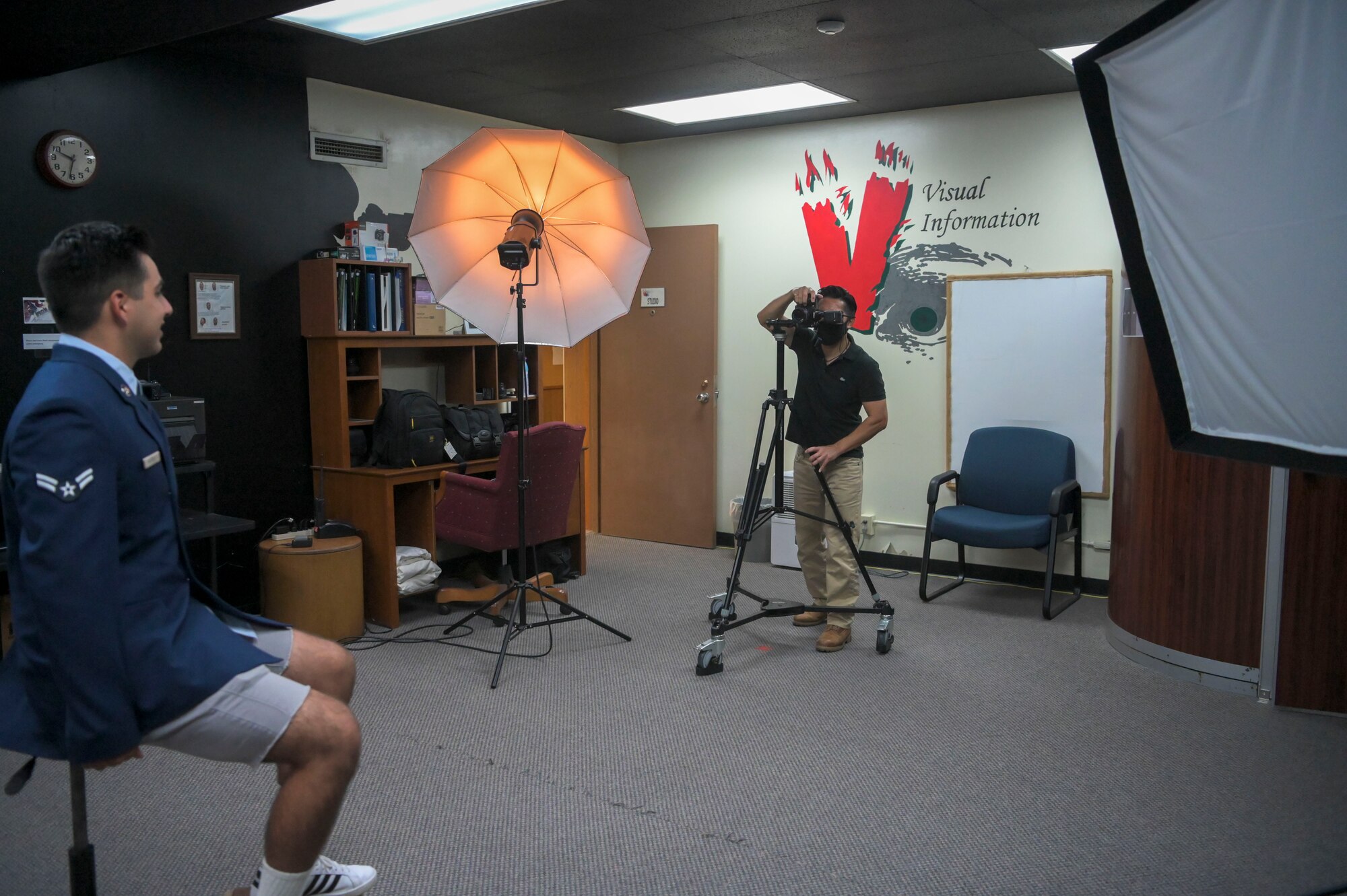 Photographer prepares to take photo of customer