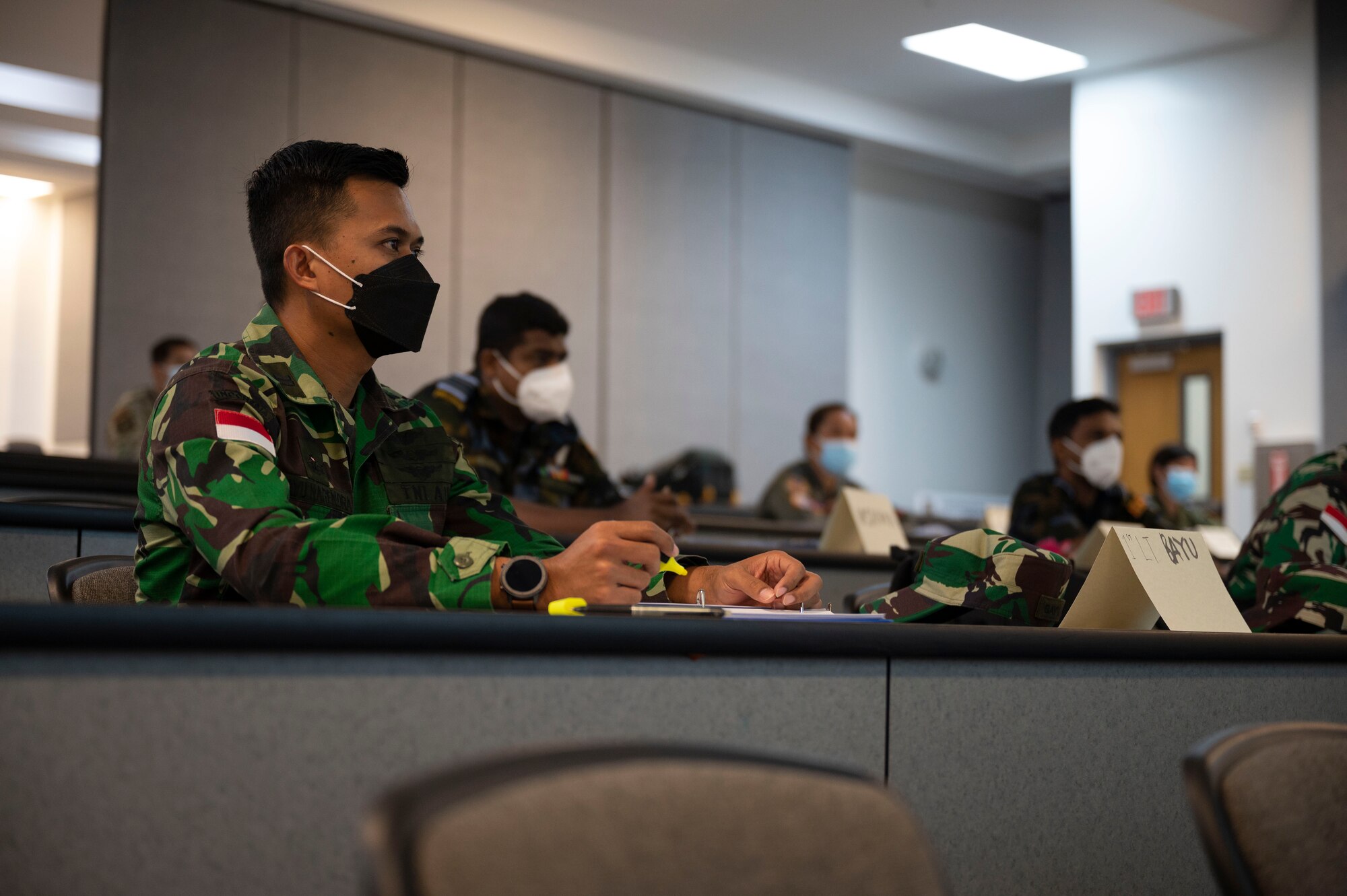 Multinational students take notes during a lecture at Andersen Air Force Base, Guam, Aug. 12, 2021.