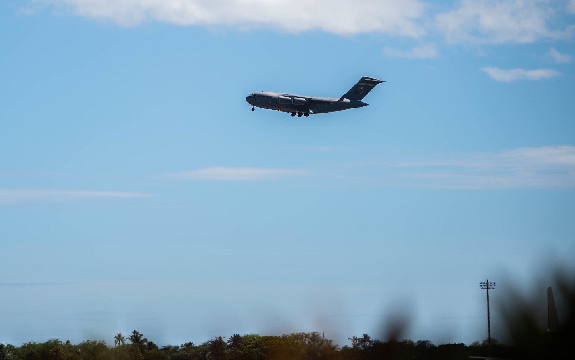 A C-17 Globemaster III, crewed by active-duty Airmen from the 535th Airlift Squadron and a Hawaii Air National Guard member from the 204th AS, prepares to land at Joint Base Pearl Harbor-Hickam, Hawaii, Sept. 7, 2021. The five aircrew members flew an estimated 14 hours and completed four sorties while supporting evacuation operations out of Afghanistan. (U.S. Air Force photo by Senior Airman Alan Ricker)