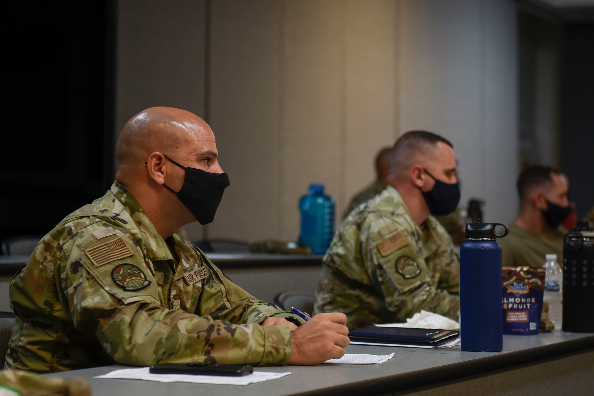 A man sitting at a table taking notes.