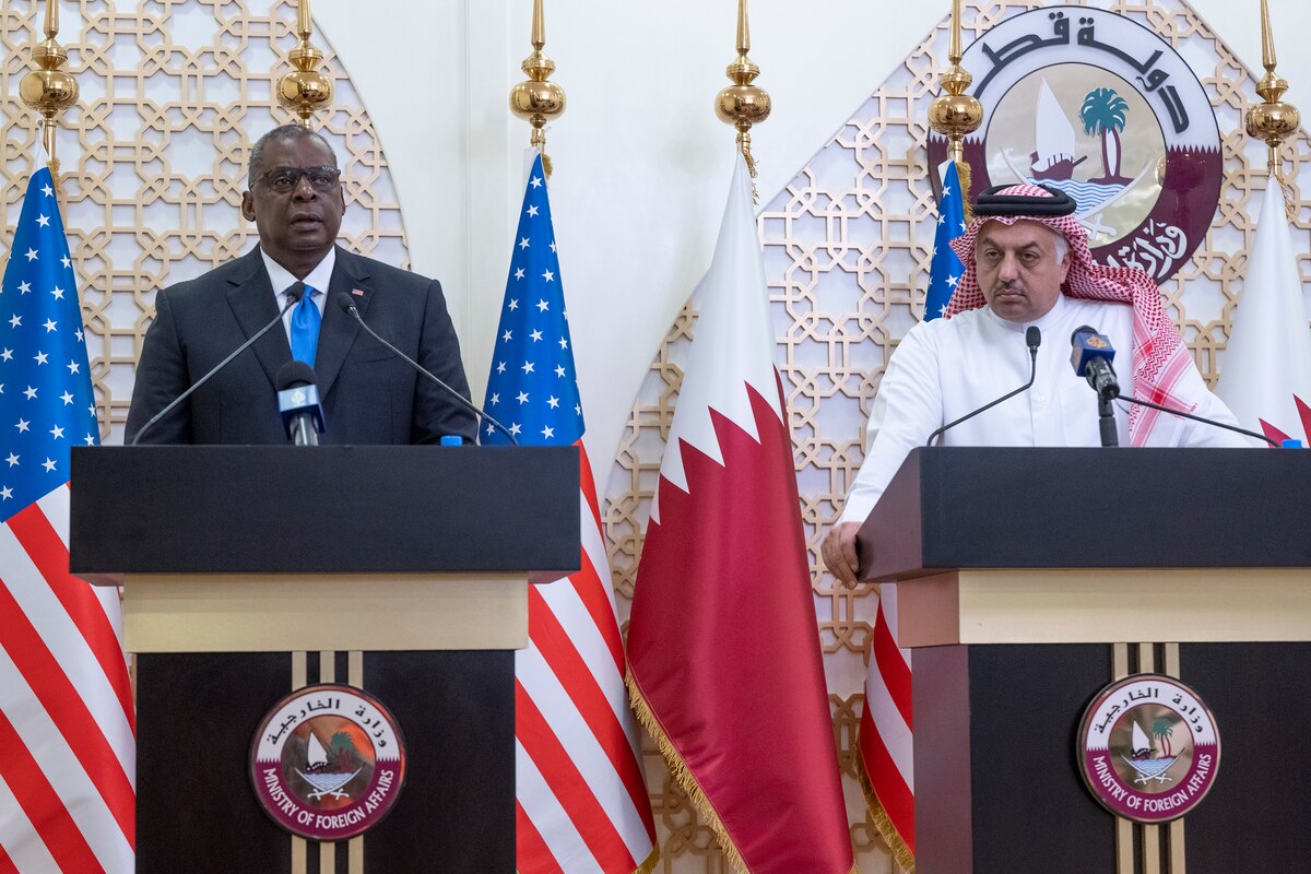 Secretary of Defense Lloyd J. Austin III speaks at a lectern with another official.