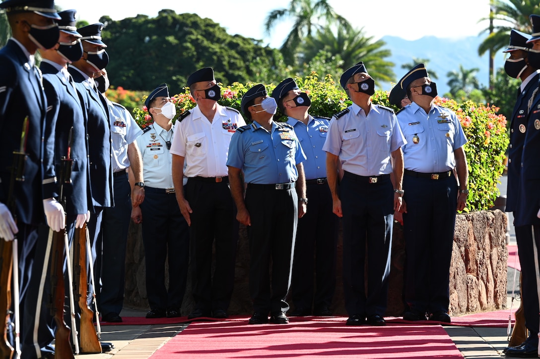 Air chiefs from nations across the Indo-Pacific region view a flyover during the opening ceremony of the Pacific Air Chiefs Symposium 2021 at Joint Base Pearl Harbor-Hickam, Hawaii, Aug. 31, 2021. The symposium provided an opportunity for air chiefs across the Indo-Pacific region to share dialogue and to build mutual understanding of regional perspectives through bilateral engagements and multinational panels and meetings.