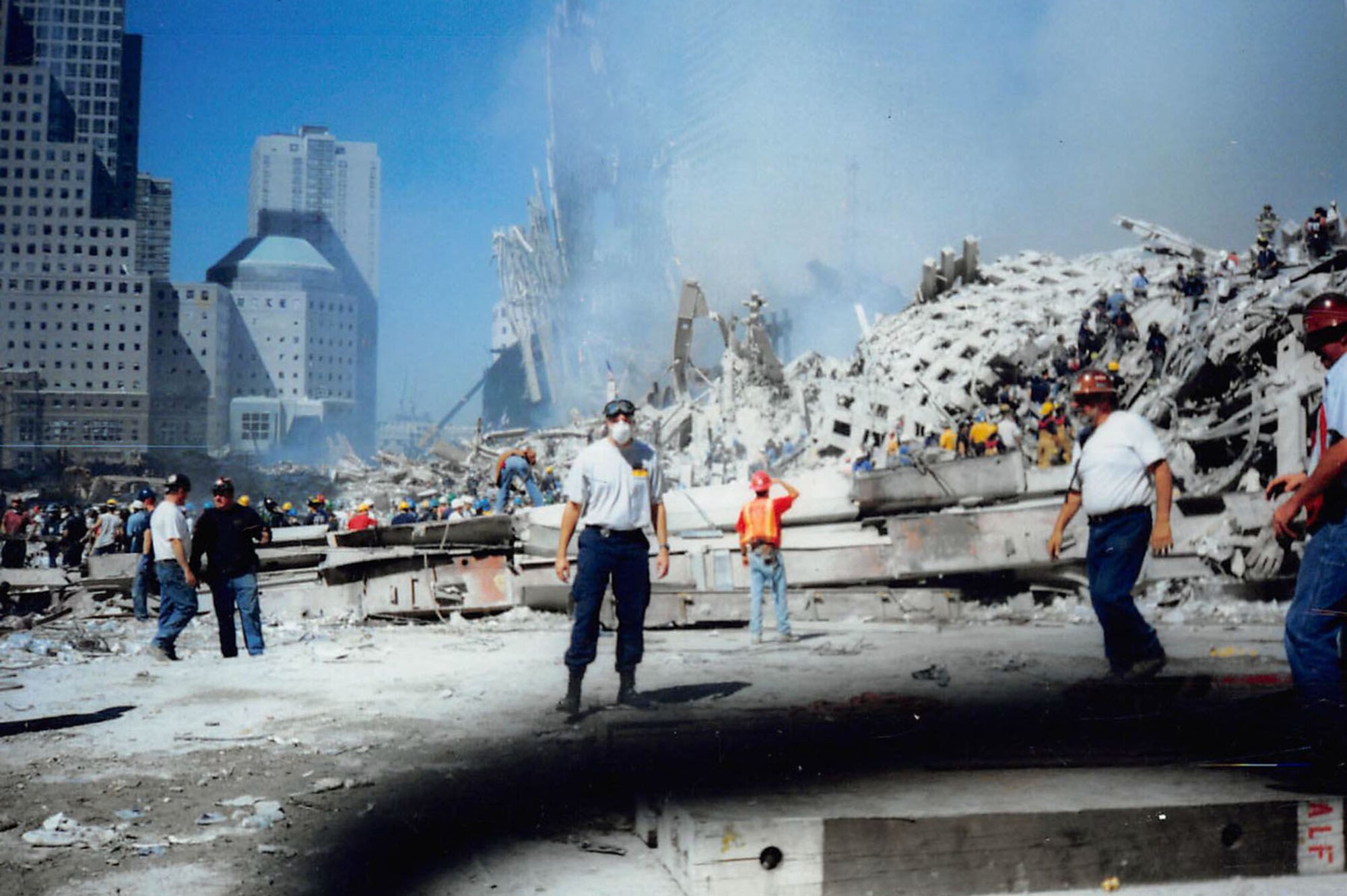 A man stands outside the wreckage at Ground Zero in New York.