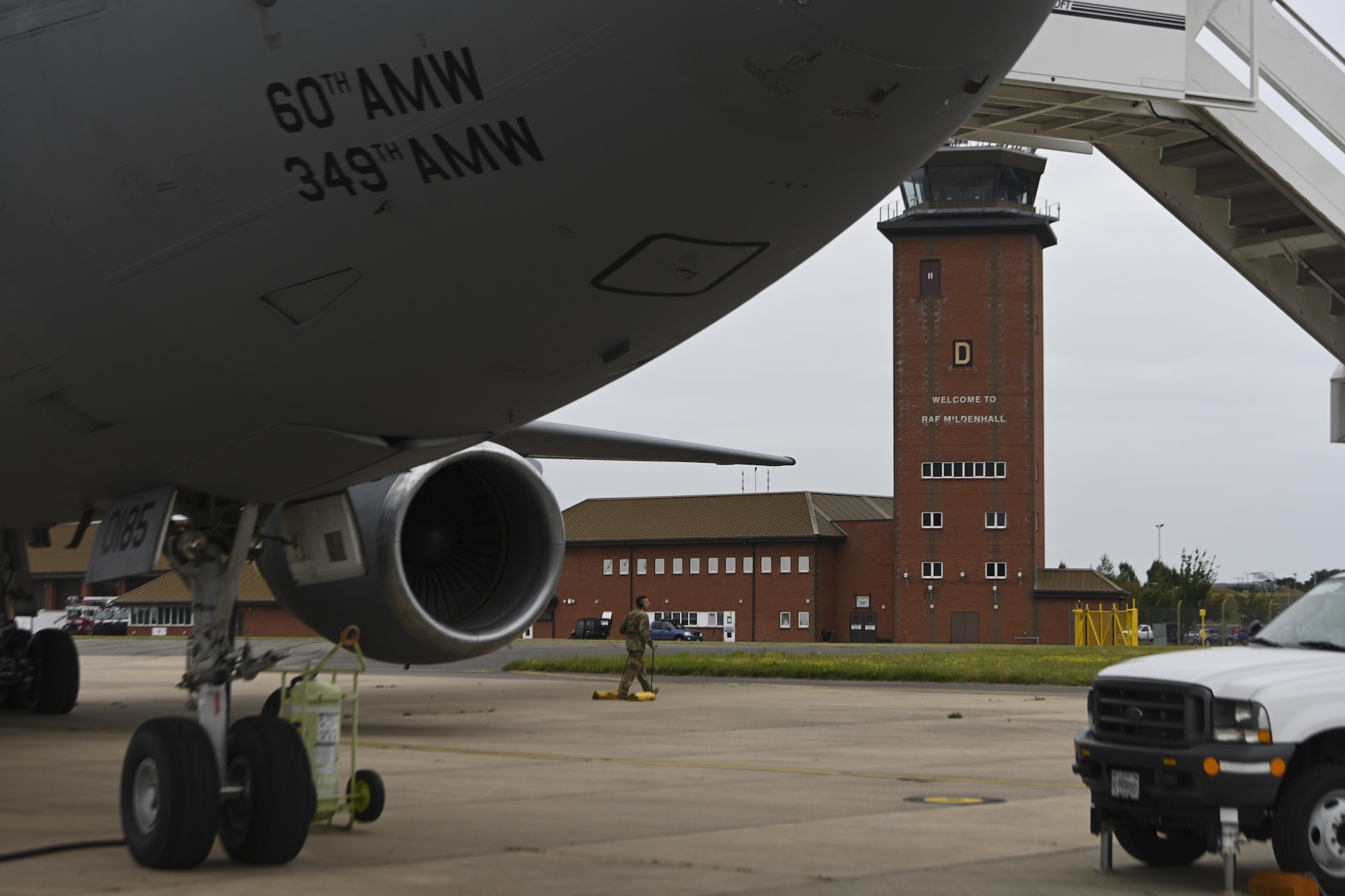 A U.S. Air Force Airmen assigned to the 60th Air Mobility Wing, Travis Air Force Base, California, removes a wheel chock from a KC-10 Extender aircraft in preparation for flight at Royal Air Force Mildenhall, England, Sept. 2, 2021. RAF Mildenhall supported the 60th Air Mobility Wing in evacuation operations during Operation Allies Refuge. (U.S. Air Force photo by Senior Airman Joseph Barron)