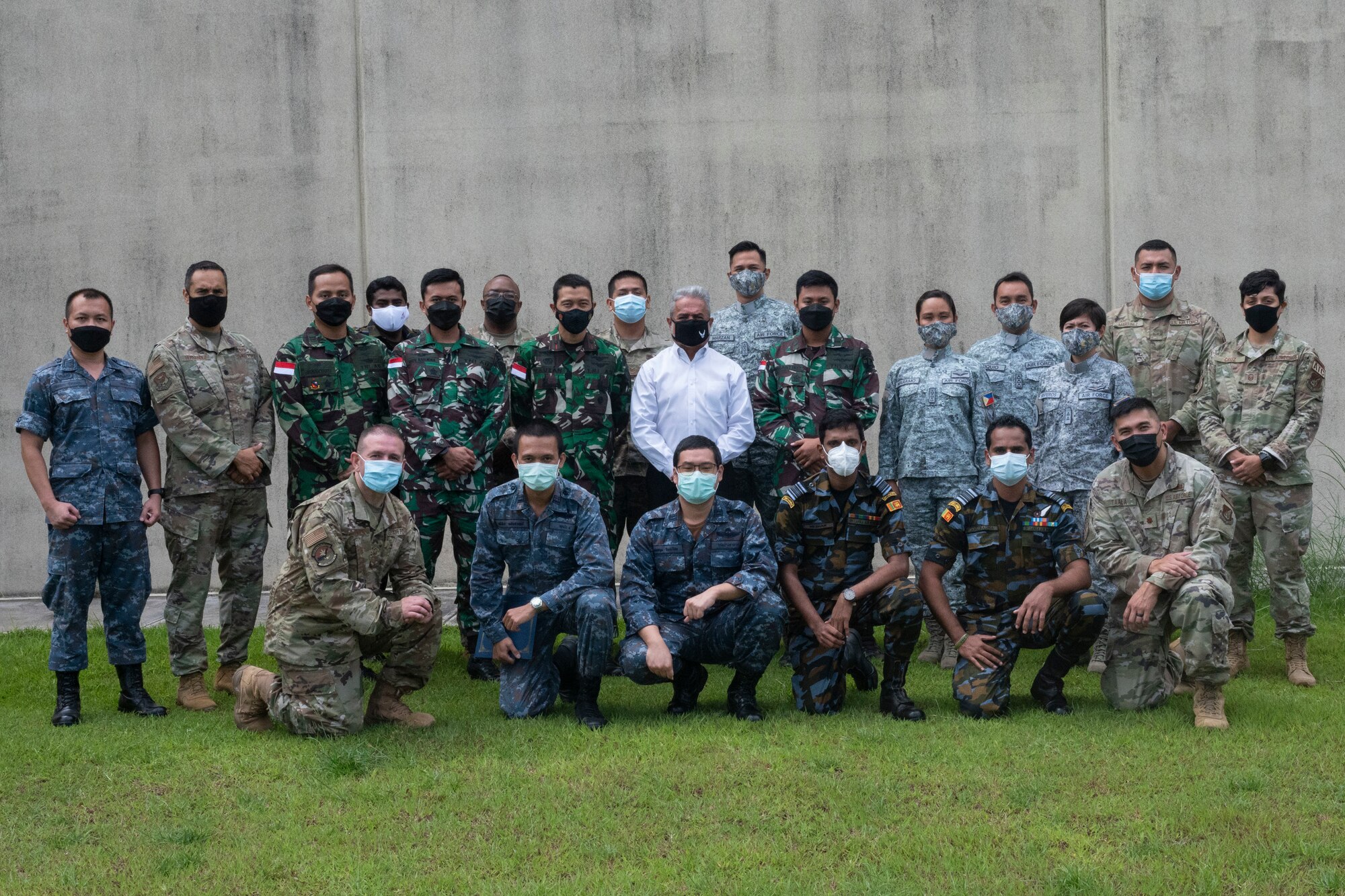 U.S. Air Force instructors from the Inter-American Air Forces Academy pose with international students after the Aircraft Maintenance Officer Course Event graduation ceremony at Andersen Air Force Base, Guam, Aug. 20, 2021.
