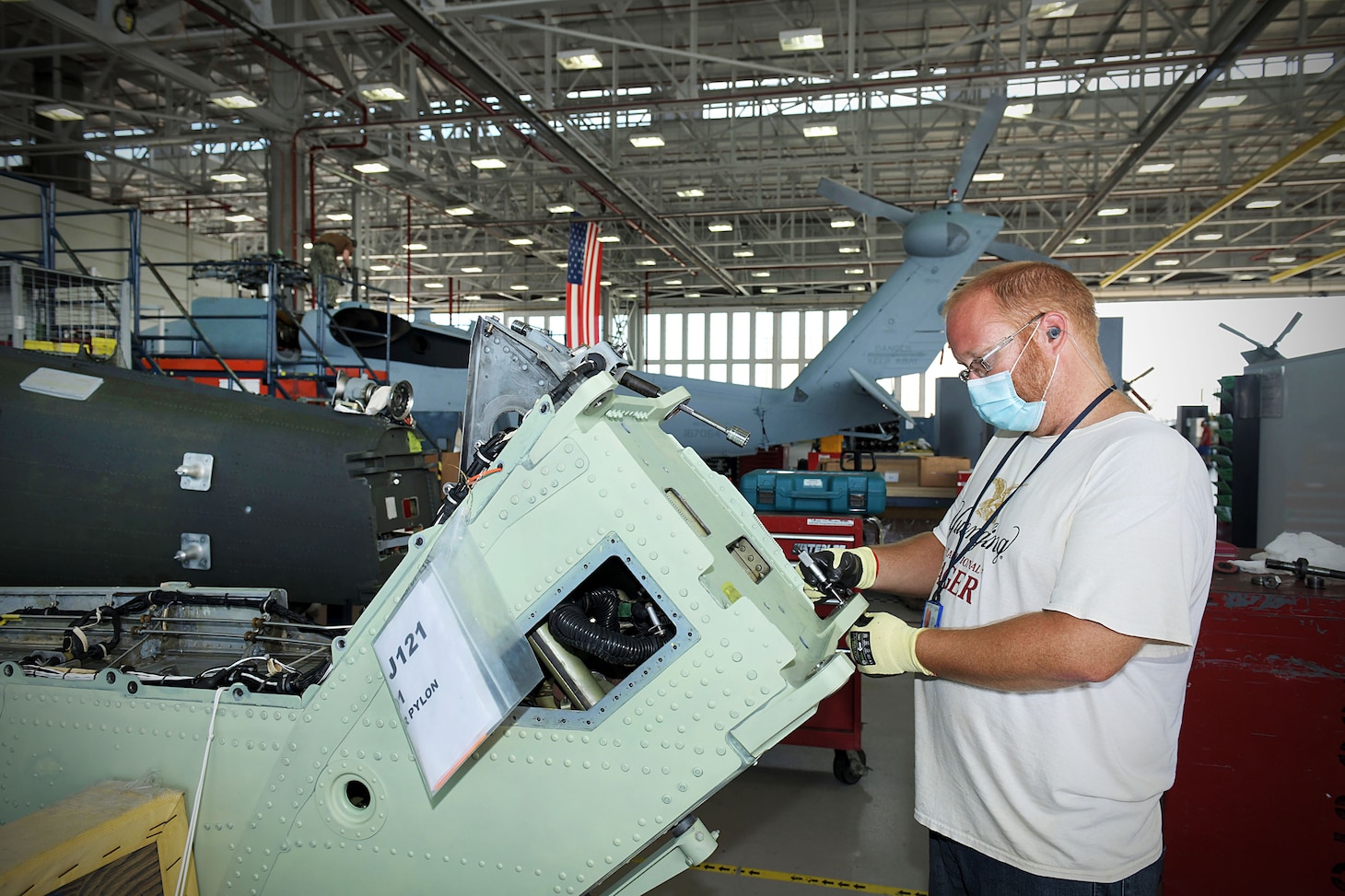 Christopher Whiting measures a pylon bulk head lug as he replaces bad bushings on an H-60 aircraft.