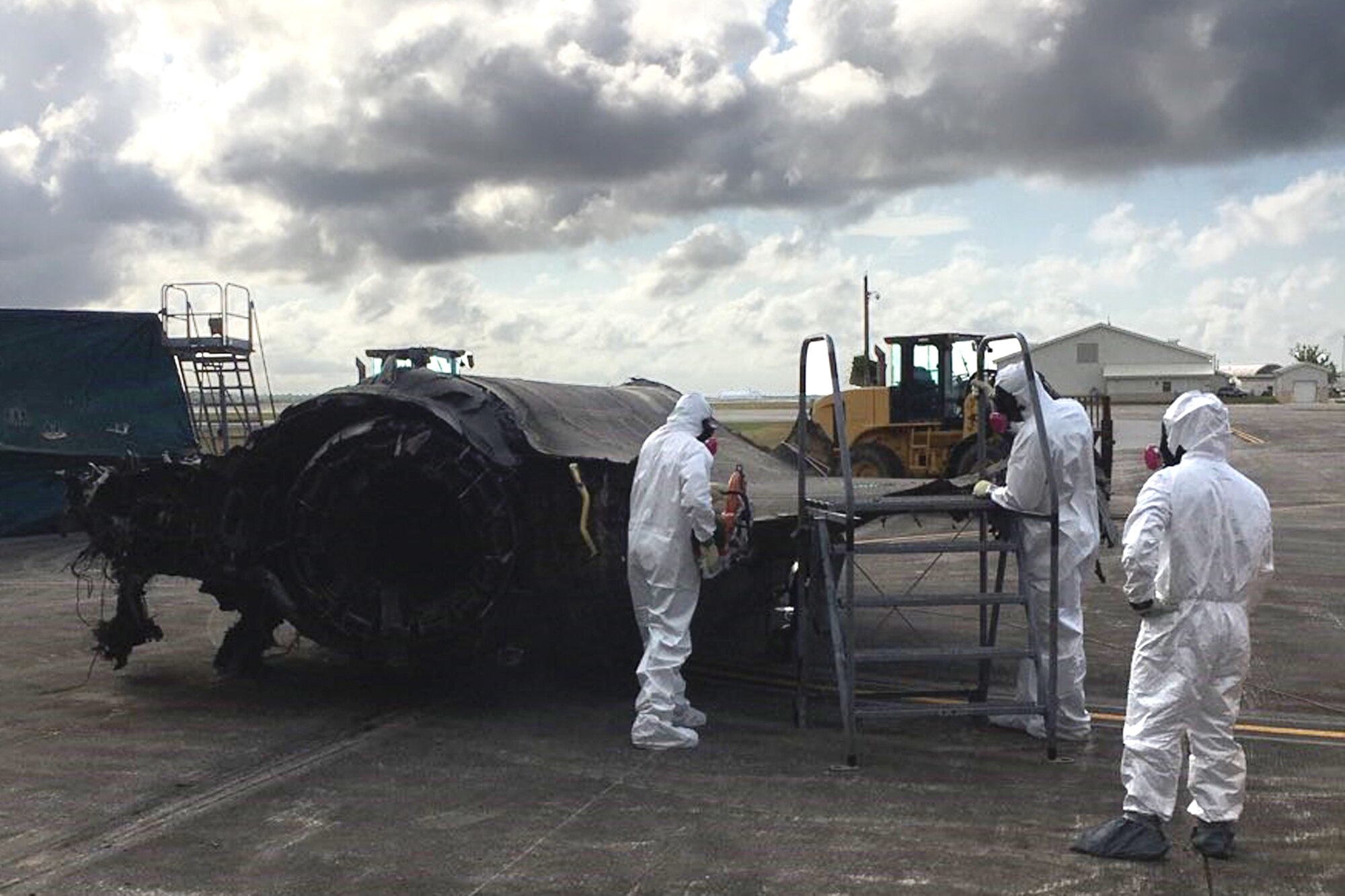 (Left to right) Staff Sgt. Cameron Salmon and Staff Sgt. Steven Kuethe, Ogden Air Logistics Complex aircraft battle damage and repair, and Master Sgt. Andrew Wilkow, 372nd Training Squadron, Det. 3, cut off the wing of a condemned F-35A Lightning II and prep it for transport at Eglin Air Force Base, Florida. The aircraft was involved in a landing mishap at Eglin in 2020 and Airmen at Hill AFB, Utah, are currently involved in transforming it into sectional training aids for use during instruction of F-35 maintainers.