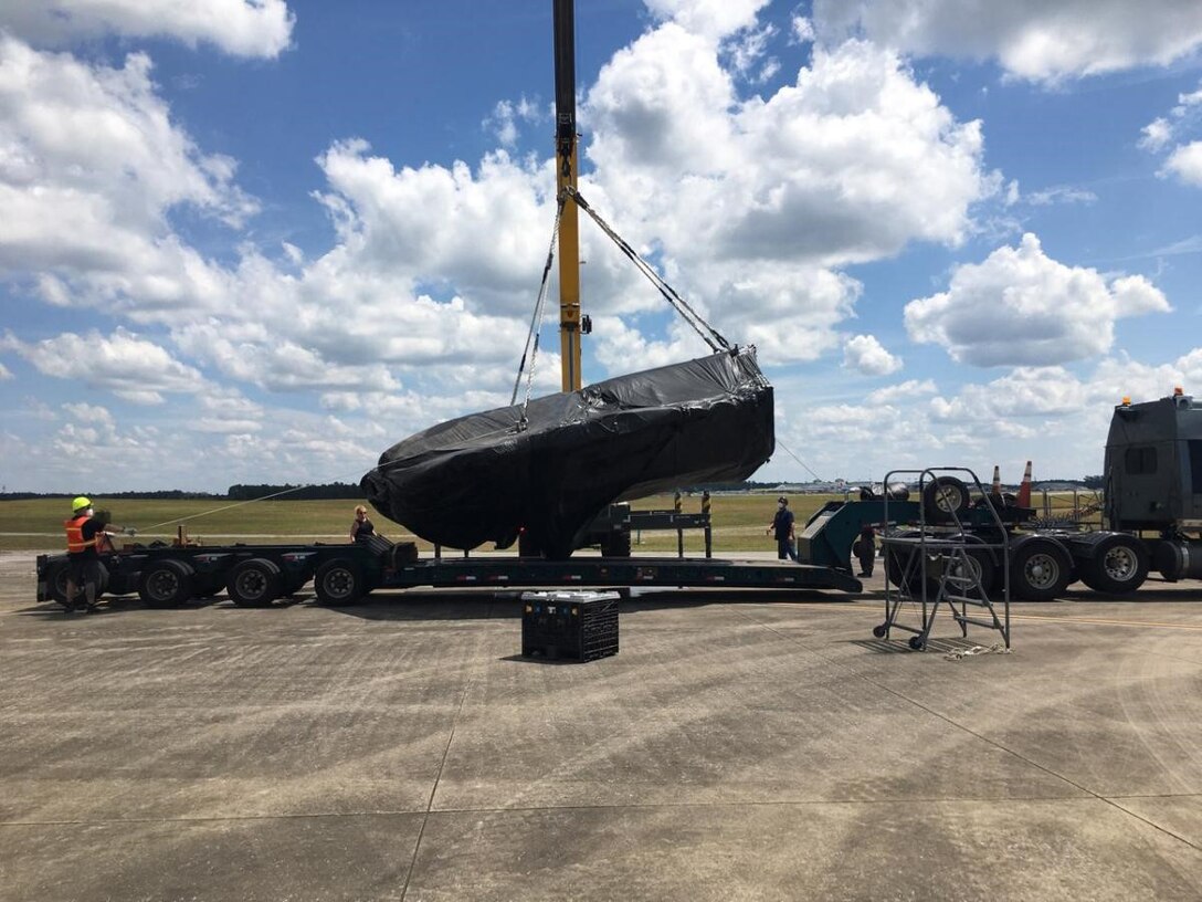 A crew loads the fuselage of a condemned F-35A Lightning II onto a flatbed trailer at Eglin Air Force Base, Florida, for transport to Hill AFB, Utah.  The aircraft was involved in a landing mishap at Eglin in 2020, but is now at Hill AFB where Airmen are currently involved in transforming it into sectional training aids for use during instruction of F-35 maintainers.