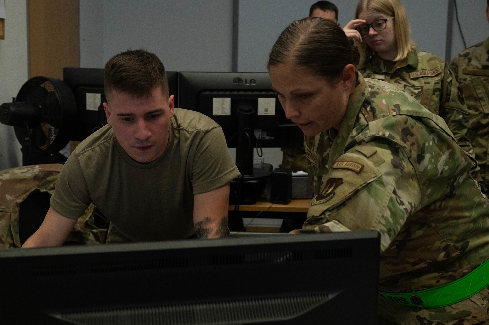 Airmen work on computer.