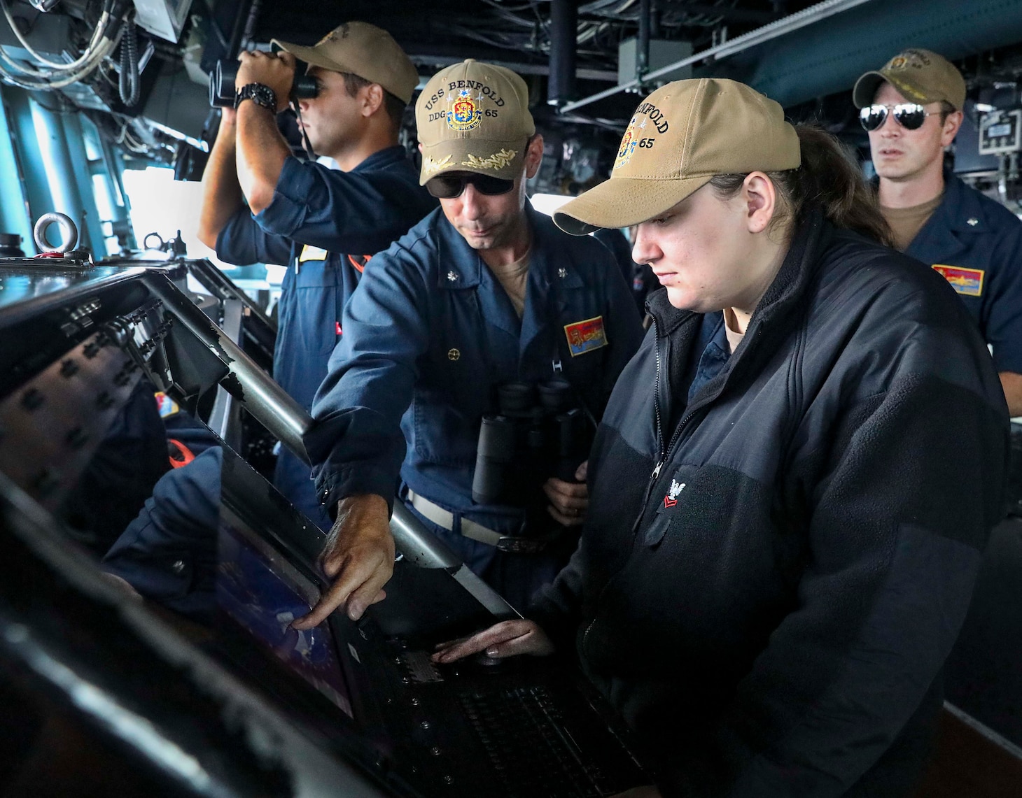 SOUTH CHINA SEA (Sept. 08, 2021) Operations Specialist 2nd Class Brittany Sopolosky, from Anderson, S.C., monitors surface contacts from the bridge of the Arleigh Burke-class guided-missile destroyer USS Benfold (DDG 65) as the ship transits the South China Sea conducting routine underway operations. Benfold is forward-deployed to the U.S. 7th Fleet area of operations in support of a free and open Indo-Pacific. (U.S. Navy photo by Mass Communication Specialist 1st Class Deanna C. Gonzales)