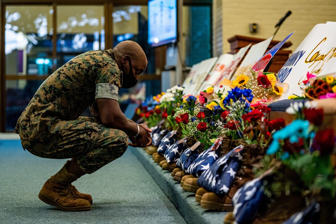 A U.S. Marine mourns at the memorial service for the 13 service members who were killed in action in Kabul, Afghanistan, on Sept. 3, 2021, on Camp Foster, Okinawa, Japan. (U.S. Marine Corps photo by Cpl. Brennan J. Beauton)