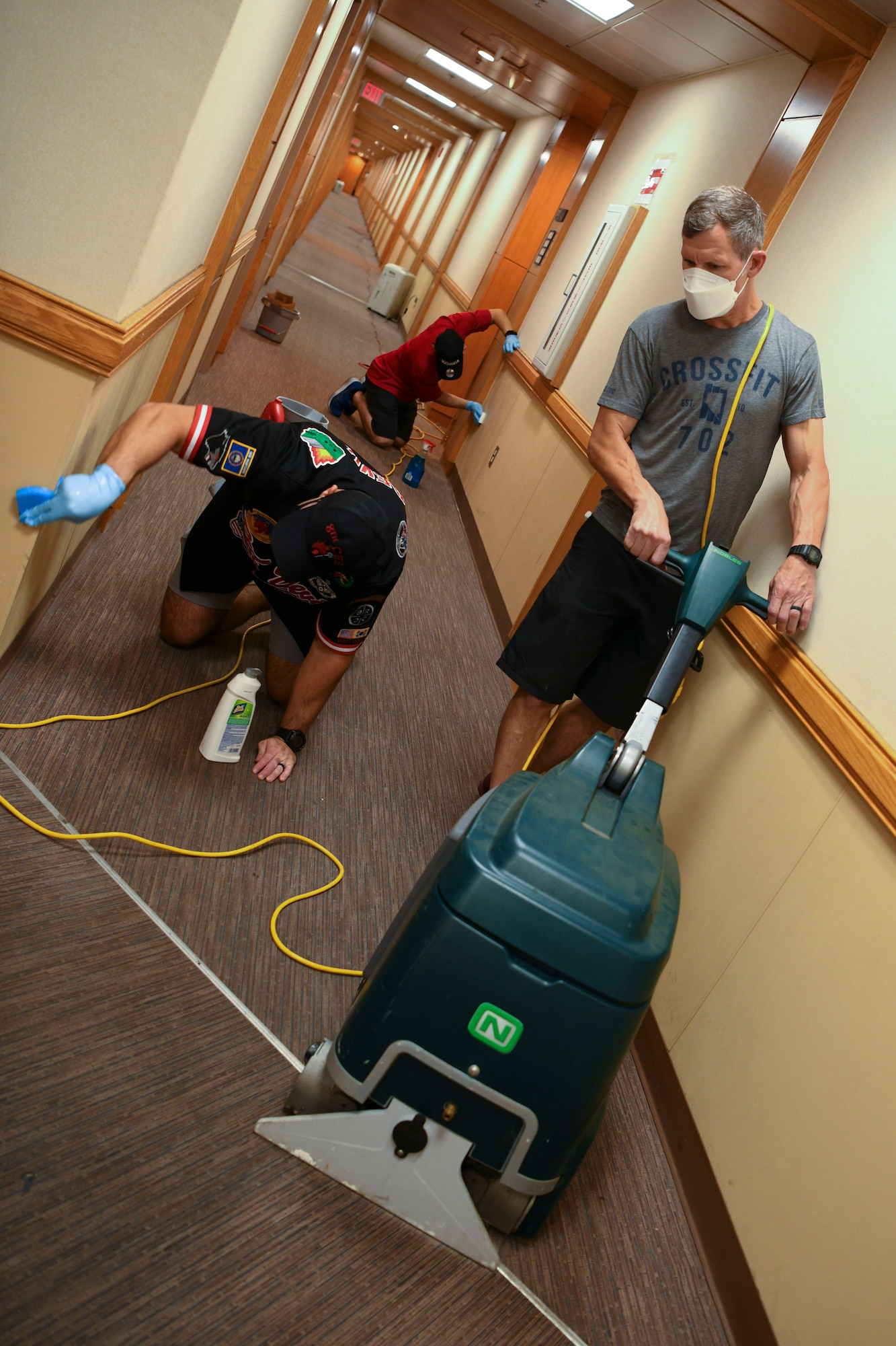 Airmen clean a base.
