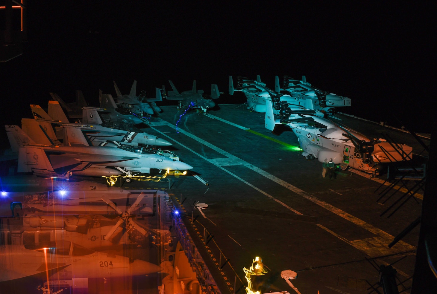 SOUTH CHINA SEA (Sept. 5, 2021) Sailors assigned to Nimitz-class aircraft carrier USS Carl Vinson (CVN 70) move aircraft from the hangar bay to the flight deck Sept. 5, 2021. Carl Vinson Carrier Strike Group is on a scheduled deployment in the U.S. 7th Fleet area of operations to enhance interoperability with allies and partners while serving as a ready-response force in support of a free and open Indo-Pacific region. (U.S. Navy photo by Mass Communication Specialist 2nd Class Christian M. Huntington)