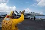 SOUTH CHINA SEA (Sept. 6, 2021) An F/A-18E Super Hornet, assigned to the “Golden Dragons” of Strike Fighter Squadron (VFA) 192, prepares to launch off the flight deck aboard Nimitz-class aircraft carrier USS Carl Vinson (CVN 70), Sept. 6, 2021. Carl Vinson Carrier Strike Group is on a scheduled deployment in the U.S. 7th Fleet area of operations to enhance interoperability with allies and partners while serving as a ready-response force in support of a free and open Indo-Pacific region. (U.S. Navy photo by Mass Communication Specialist Seaman Isaiah Williams)