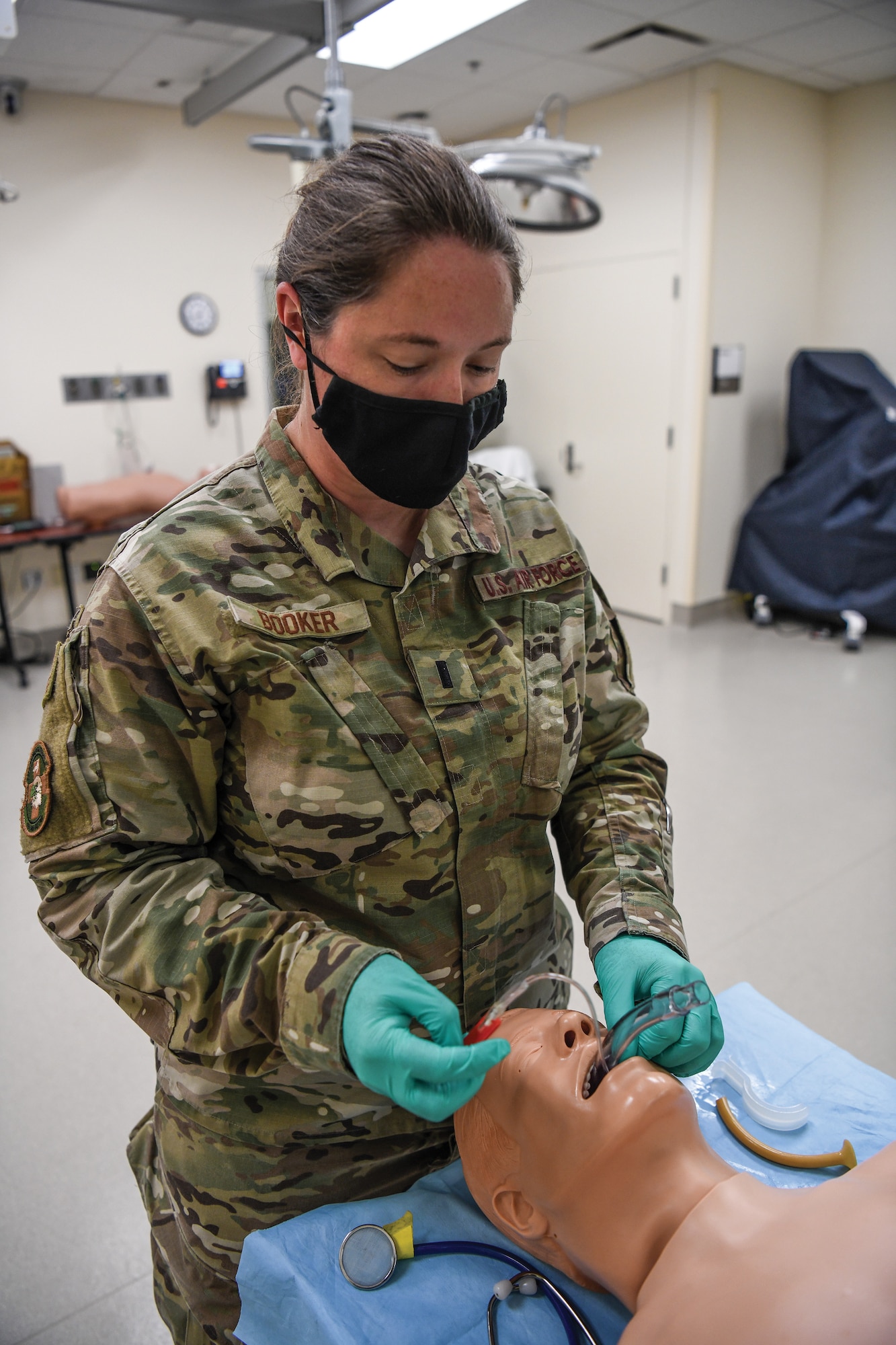 First Lt. Charran Booker, 445th Aeromedical Staging Squadron clinical nurse, applies a nasal pharyngeal to a “patient” for airway management at the Dayton Veterans Affairs Medical facility simulation lab Aug. 6, 2021.