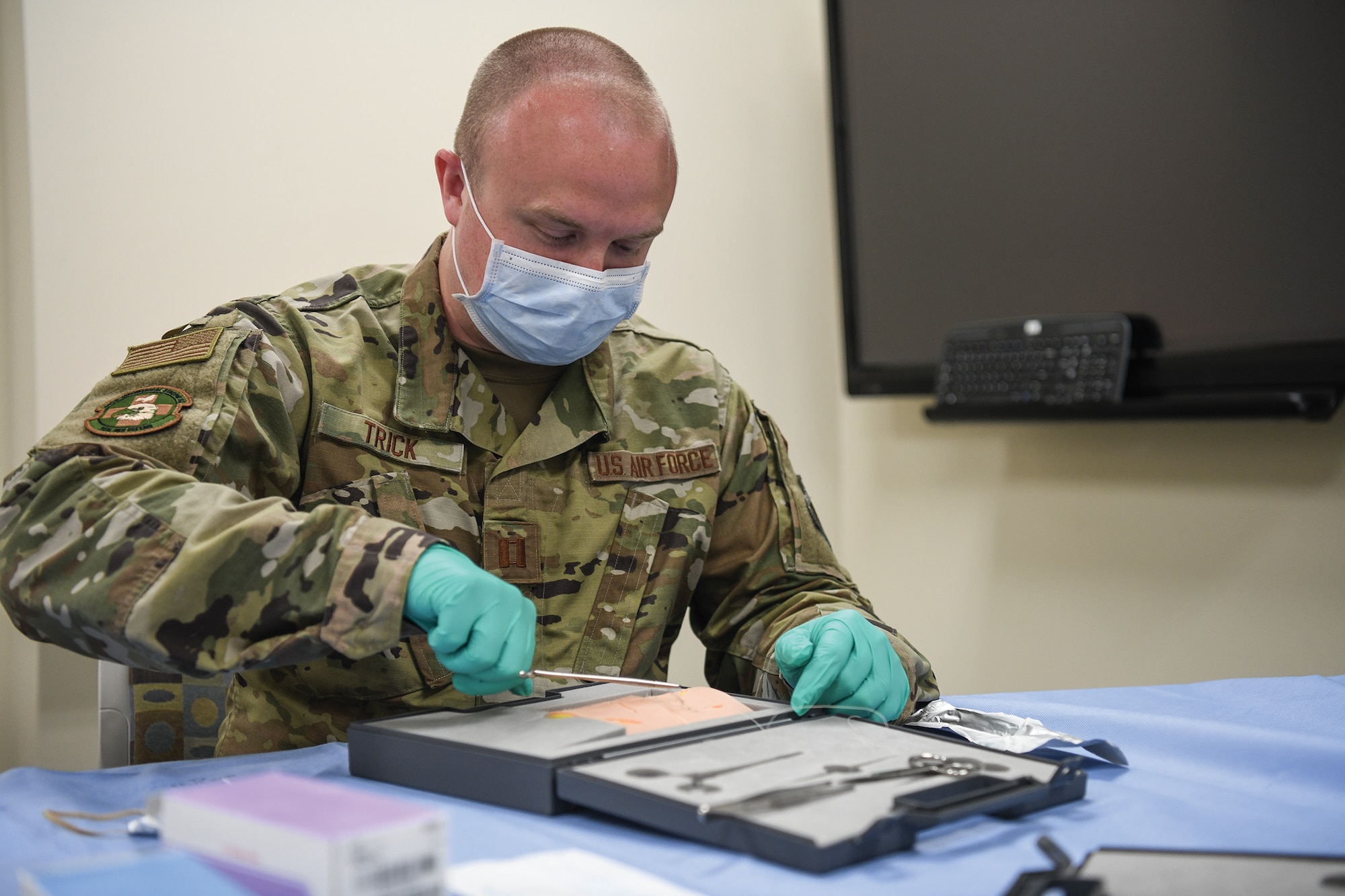 Capt. Benjamin Trick, 445th Aeromedical Staging Squadron simulation lab supervisor, applies a one notch suture on simulated skin at the Dayton Veterans Affairs Medical facility simulation lab Aug. 6, 2021.