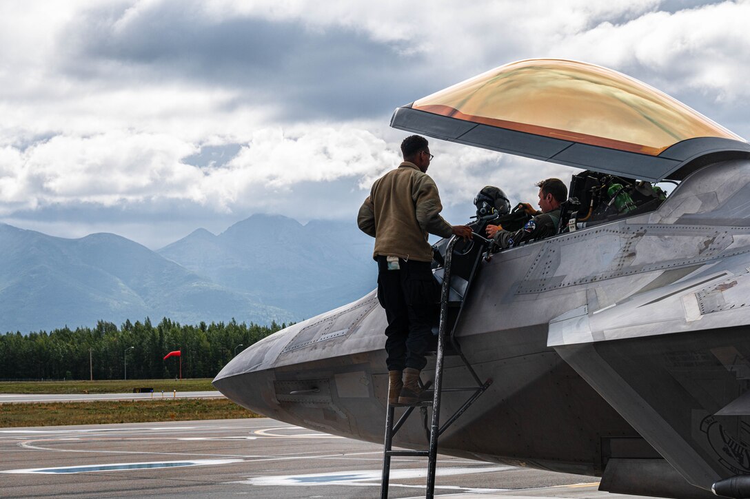 A maintainer greets a pilot.