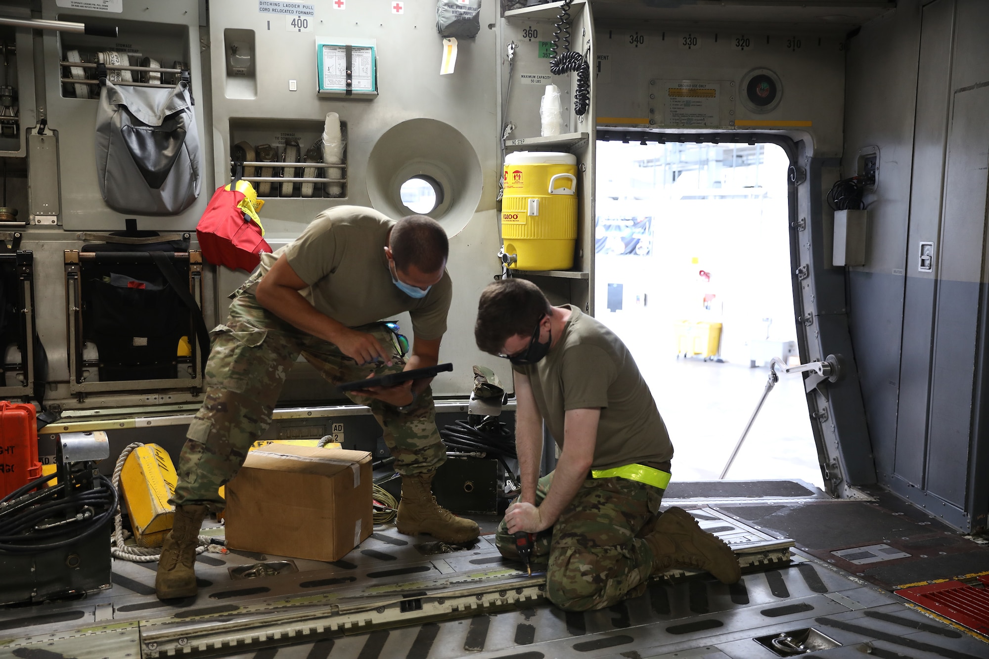 Senior Airmen Derek Reighard and Matthew Fahs, 445th Aircraft Maintenance Squadron crew chiefs, reinstall rails on a 445th Airlift Wing C-17 Globemaster III at Wright Patterson Air Force Base, Ohio Aug. 22, 2021.  Rails of the aircraft are inspected regularly for mechanical integrity and cleanliness.
