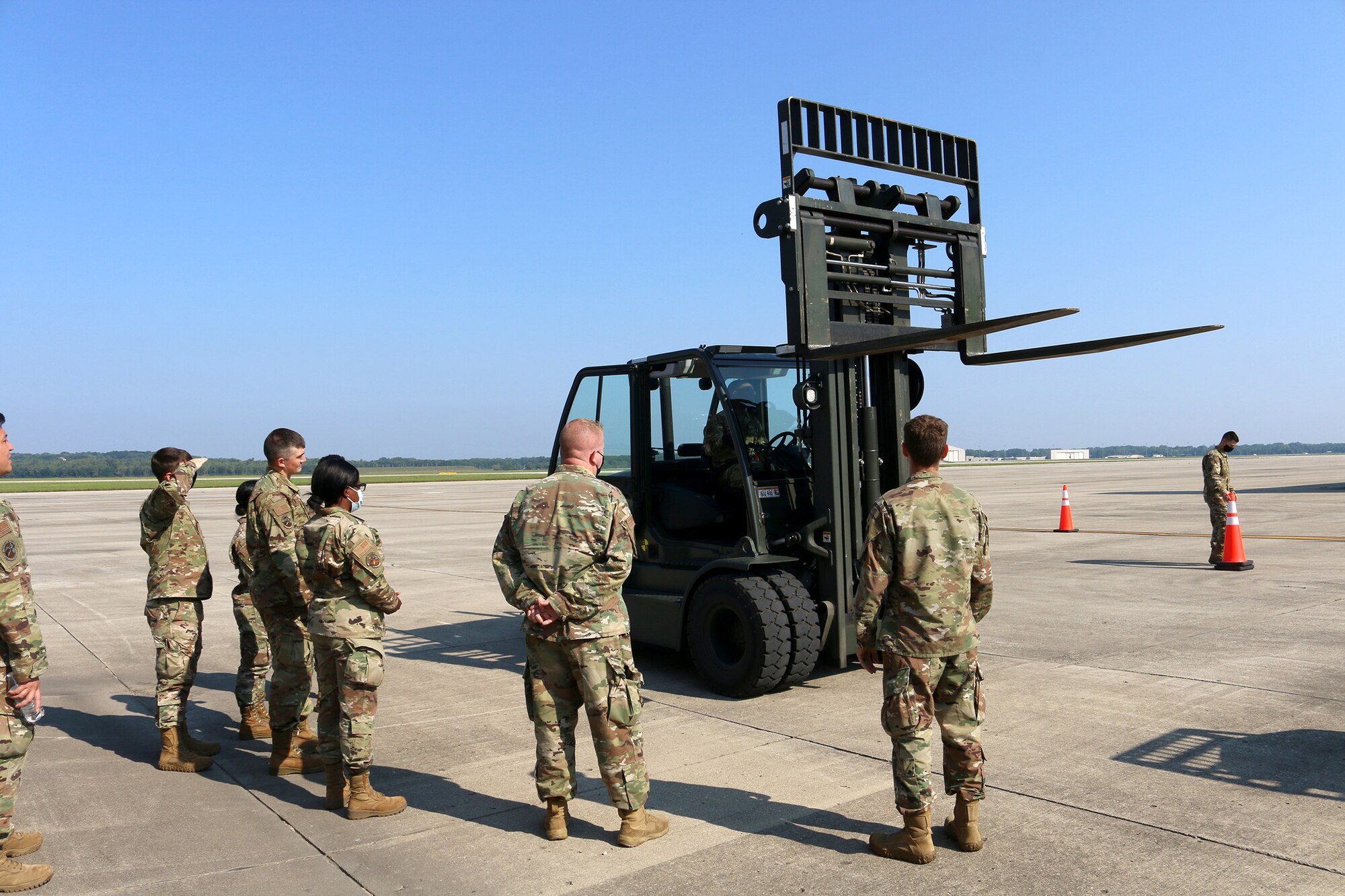 Airmen from the 445th Logistics Readiness Squadron material management flight observe a forklift in motion Aug. 22, 2021 at Wright-Patterson Air Force Base, Ohio.  The group of Airmen receiving the training were a mix of individuals that were driving a forklift for the very first time and those that were just receiving refresher training.