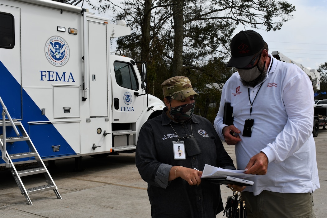 EMA and USACE representatives coordinate before attending a meeting in St. James Parish EOC.