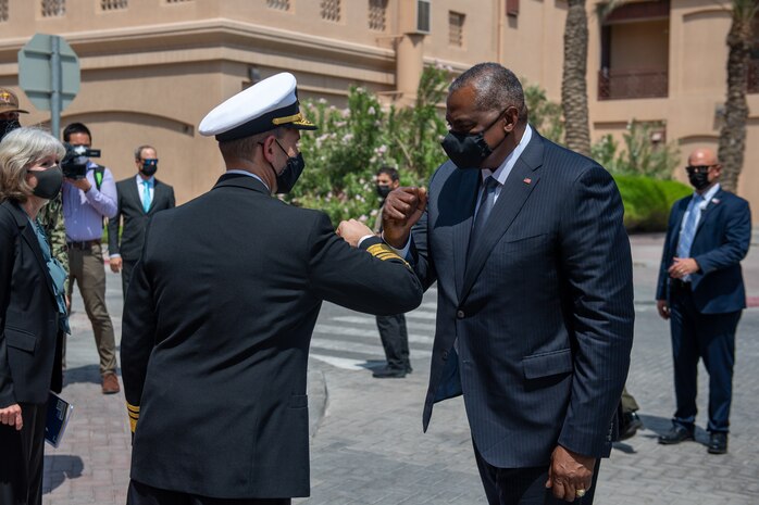 NAVAL SUPPORT ACTIVITY BAHRAIN (Sept. 8, 2021) Secretary of Defense Lloyd Austin, right, is greeted by Vice Adm. Brad Cooper, commander of U.S. Naval Forces Central Command (NAVCENT), U.S. 5th Fleet, and Combined Maritime Forces onboard Naval Support Activity Bahrain, Sept. 8. NAVCENT is the U.S. Navy element of U.S. Central Command in the U.S. 5th Fleet area of operations and encompasses about 2.5 million square miles of water area and includes the Arabian Gulf, Gulf of Oman, Red Sea and parts of the Indian Ocean. The expanse is comprised of 21 countries and includes three critical choke points at the Strait of Hormuz, the Suez Canal and the Strait of Bab al Mandeb at the southern tip of Yemen.