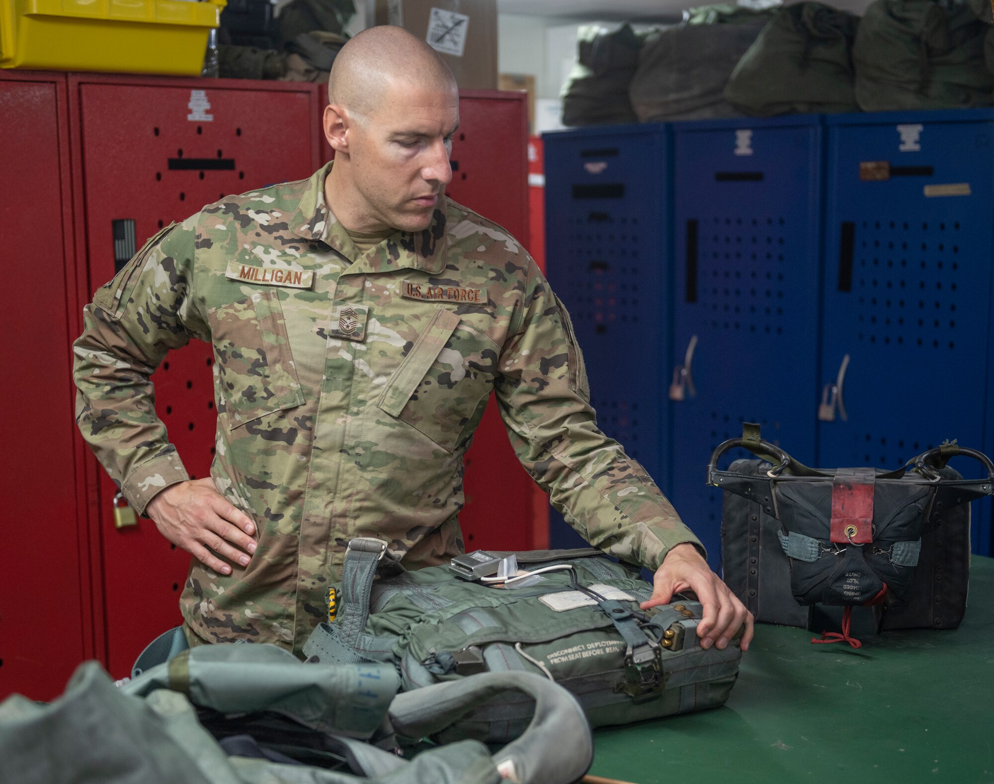 U.S. Air Force Chief Master Sgt. Sean Milligan, 332nd Air Expeditionary Wing command chief, inspects an Advanced Concept Ejection Seat II Survival Kit Sept. 4, 2021, at an undisclosed location somewhere in Southwest Asia. Aircrew flight equipment technicians ensure pilots are equipped with the specific gear needed to perform their missions. (U.S. Air Force photo by Senior Airman Cameron Otte)