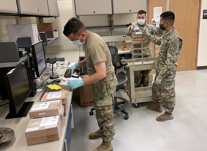 Members of the 95th Medical Detachment (Blood Support) receive units of packed red blood cells for processing July 29 at Camp Humphreys, South Korea. (Maj. Clifford Wong)