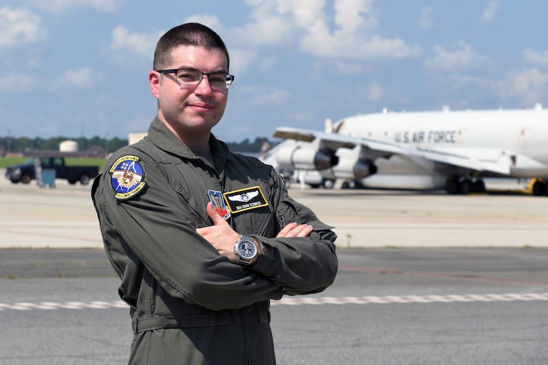 Photo shows Airman posing in front of aircraft