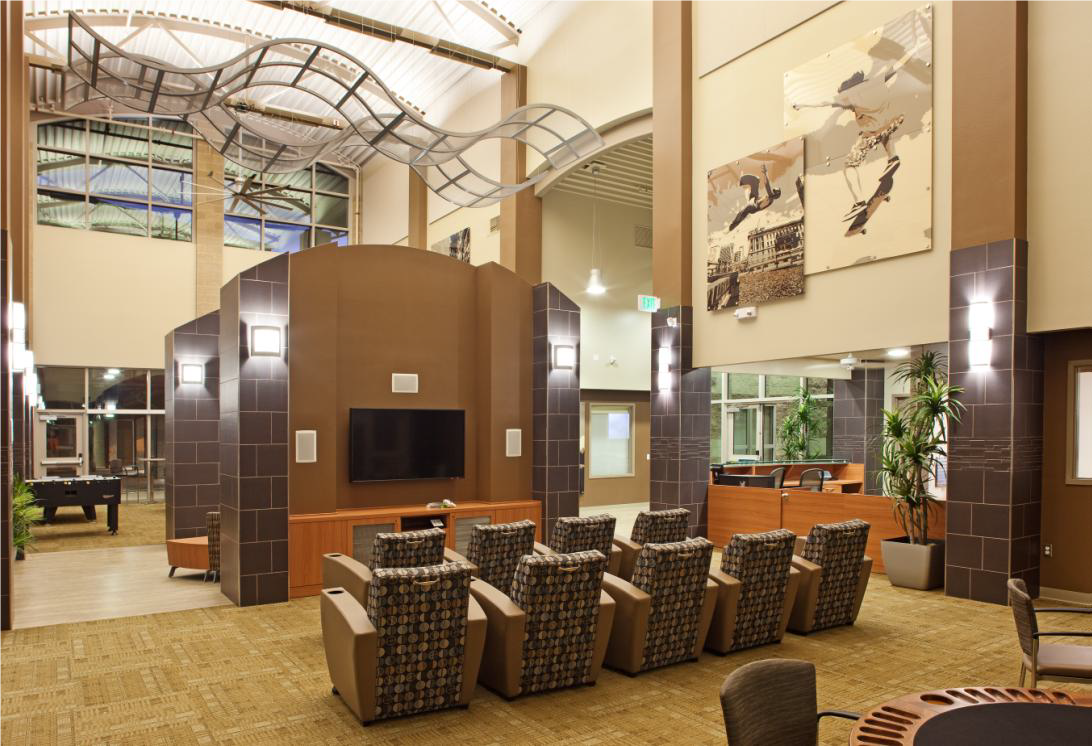 Large common area with seats facing a TV.
