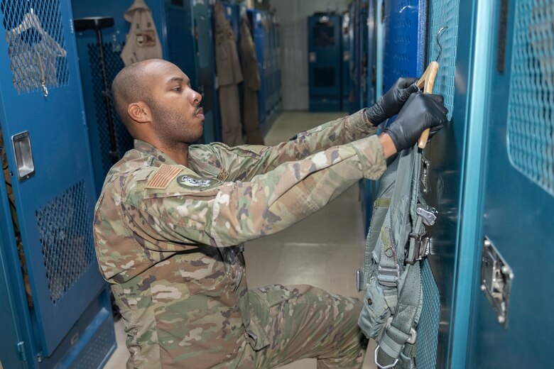 U.S. Air Force Senior Airman Rodney Tucker, 494th Expeditionary Fighter Squadron aircrew flight equipment technician, performs a preflight inspection on an F-15E Strike Eagle pilot’s equipment Sept. 7, 2021, at an undisclosed location somewhere in Southwest Asia. Aircrew flight equipment technicians ensure pilots are equipped with the specific gear needed to perform their missions. (U.S. Air Force photo by Senior Airman Cameron Otte)