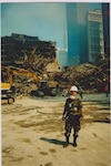 New York Army National Guard Maj. Edward Keyrouze assists at the still smoldering "rubble pile" at Ground Zero following the attack on the World Trade Center towers in New York Sept. 11, 2001. More than 14,000 members of the New York National Guard responded to the attack.