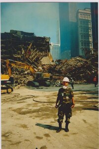 New York Army National Guard Maj. Edward Keyrouze assists at the still smoldering "rubble pile" at Ground Zero following the attack on the World Trade Center towers in New York Sept. 11, 2001. More than 14,000 members of the New York National Guard responded to the attack.