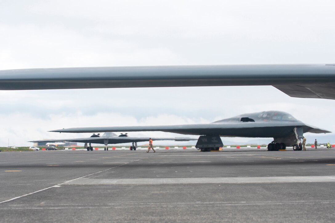 Three B-2 bombers sit on a runway.