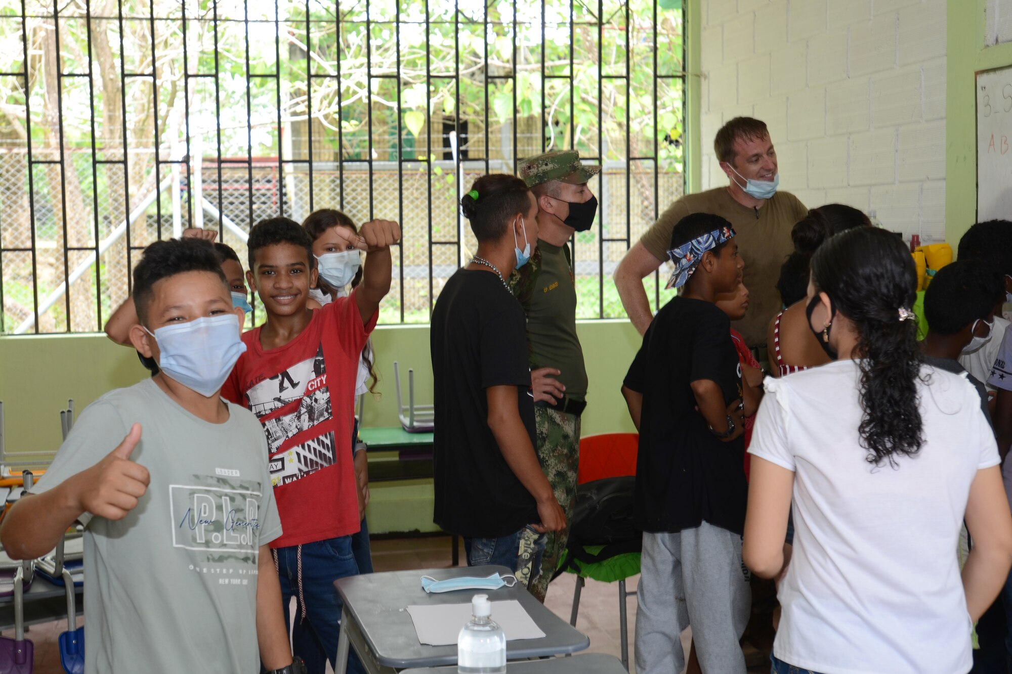 .S. Air Force Maj. Thomas Jones, an orthopedic doctor with the 169th Medical Group, teaches children English September 4, 2021. Doctors and med techs from the South Carolina Air National Guard’s 169th Medical Group teamed up with medics from the South Carolina Army National Guard to travel to the remote town of Tamana, Colombia to participate in a real-word community medical and humanitarian support mission September 4, 2021. While there, the medical personnel provided dental, optical, dermatology, pharmacy and general medical care to more than 300 patients. South Carolina Air National Guard and South Carolina Army National Guard medical personnel participate in the regional Ángel de los Andes (Angel of the Andes) and Cooperación VII exercises in Colombia August 30 to September 10, 2021. The exercises provide training opportunities with South Carolina’s state partner Colombia in realistic combat search and rescue missions as well as humanitarian aid and disaster response scenarios such as earthquakes and tsunamis. (U.S. Air National Guard photo by Lt. Col. Jim St.Clair, 169th Fighter Wing Public Affairs)