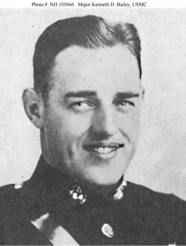 A man in dress uniform smiles for an official photo.