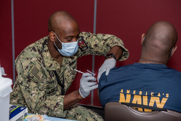 NAVAL AIR FACILITY ATSUGI, Japan (Sept. 8, 2021) Hospital Corpsman 2nd Class James Owen, from Tobyhanna, Pa., administers the Pfizer vaccine to a Sailor onboard Naval Air Facility Atsugi Sept. 8, 2021.