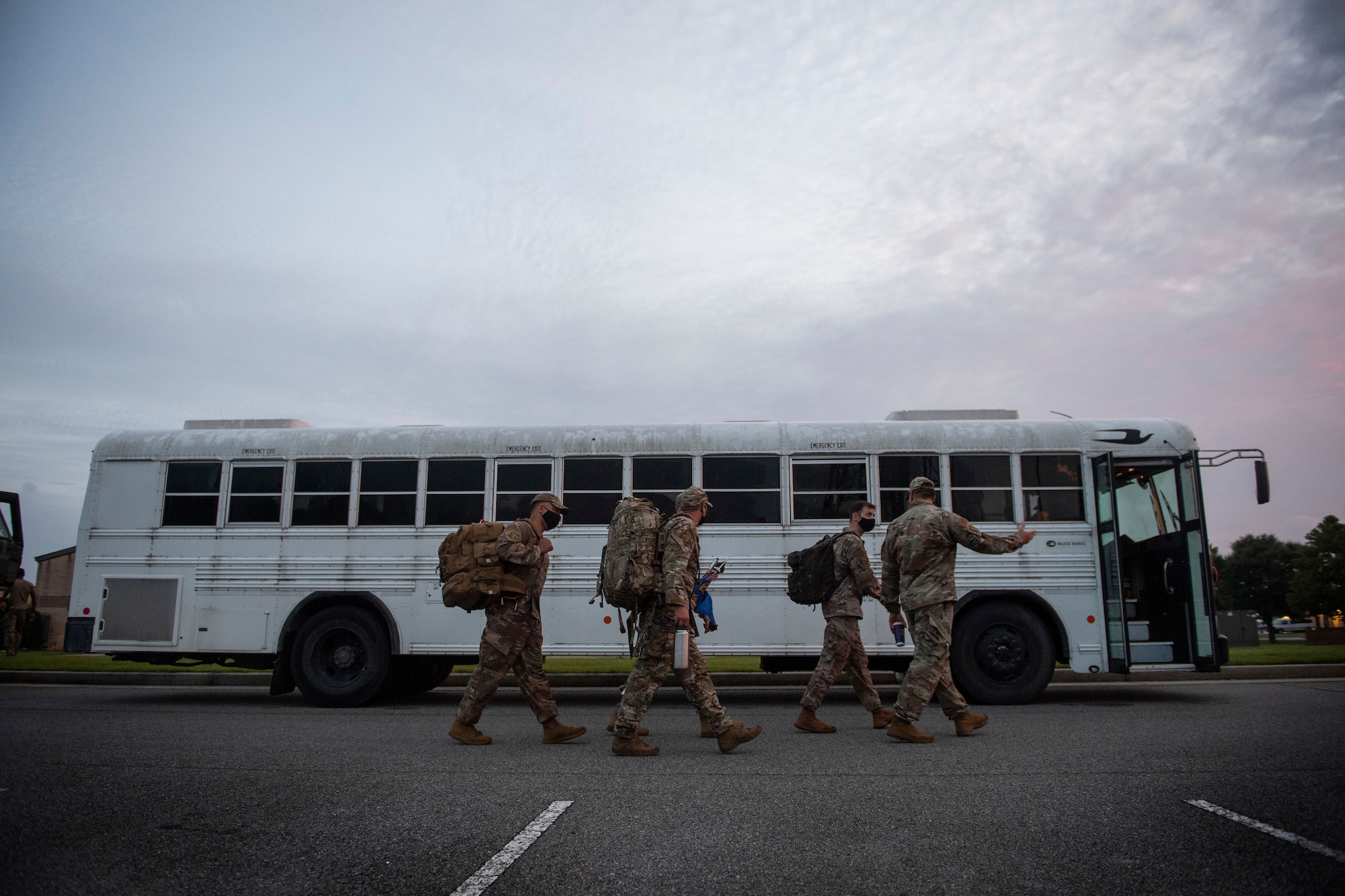 Members of the 822nd Base Defense Squadron board a bus headed from their squadron building to the deployment control center at Moody Air Force Base, Georgia, Aug. 28, 2021. Over the course of two days, more than 160 Airmen left for Holloman Air Force Base, New Mexico, in support of Task Force – Holloman. The Department of Defense, through U.S. Northern Command, and in support of the Department of Homeland Security, is providing transportation, temporary housing, medical screening, and general support for at least 50,000 Afghan evacuees at suitable facilities, in permanent or temporary structures, as quickly as possible. This initiative provides Afghan personnel essential support at secure locations outside Afghanistan. (U.S. Air Force photo by Master Sgt. Daryl Knee)